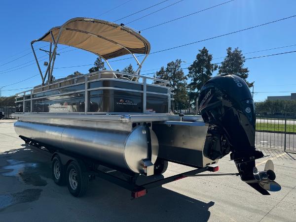 2025 Sun Tracker 24 Sportfish XP3 pontoon boat with canopy and outboard motor.