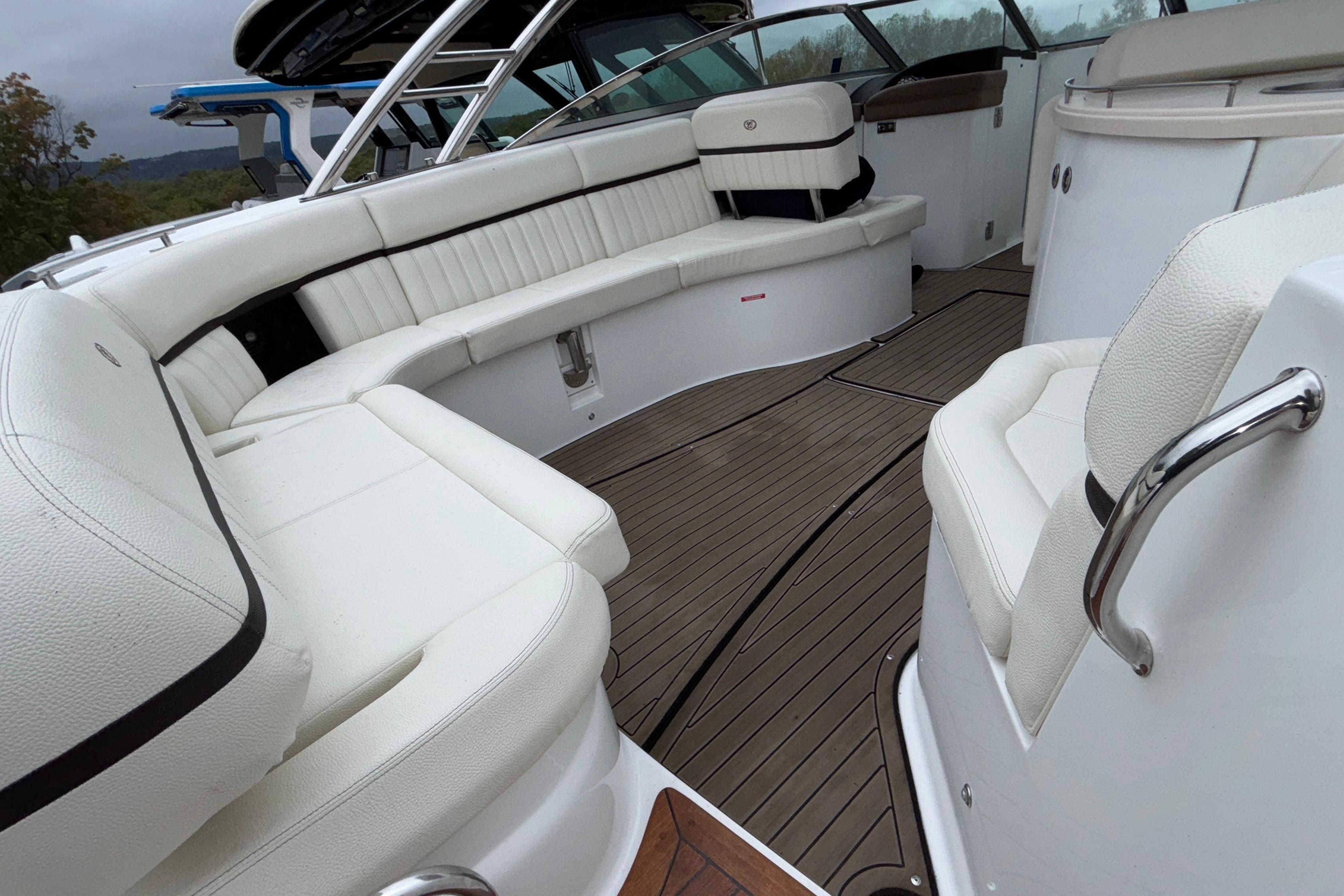 Luxurious interior of 2022 Cobalt R35 boat with white seating and wooden flooring.
