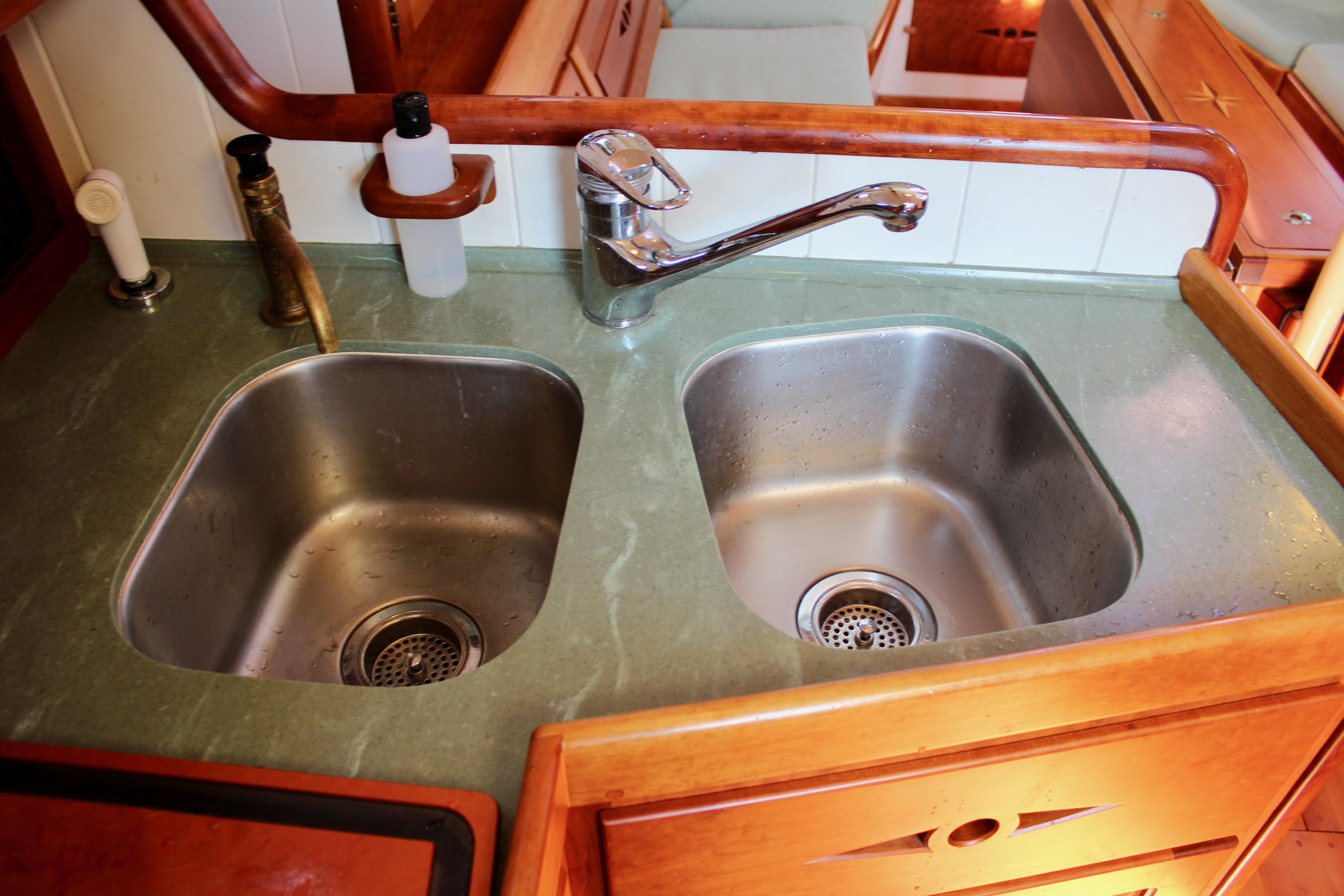 Dual stainless steel sinks in a 2012 Custom Gartside Jespersen 40 yacht kitchen.