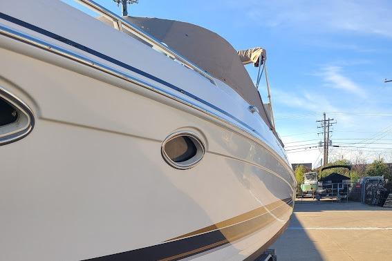 2002 Formula 330 Sun Sport boat docked under clear blue sky.