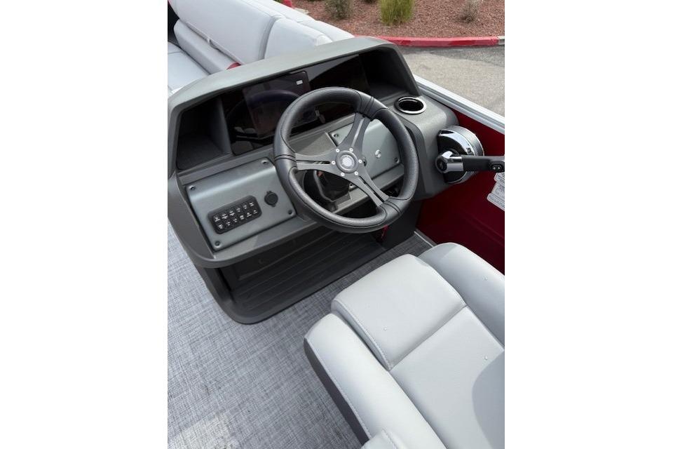 2026 Sun Tracker Party Barge 22 DLX steering console with modern controls and seating.