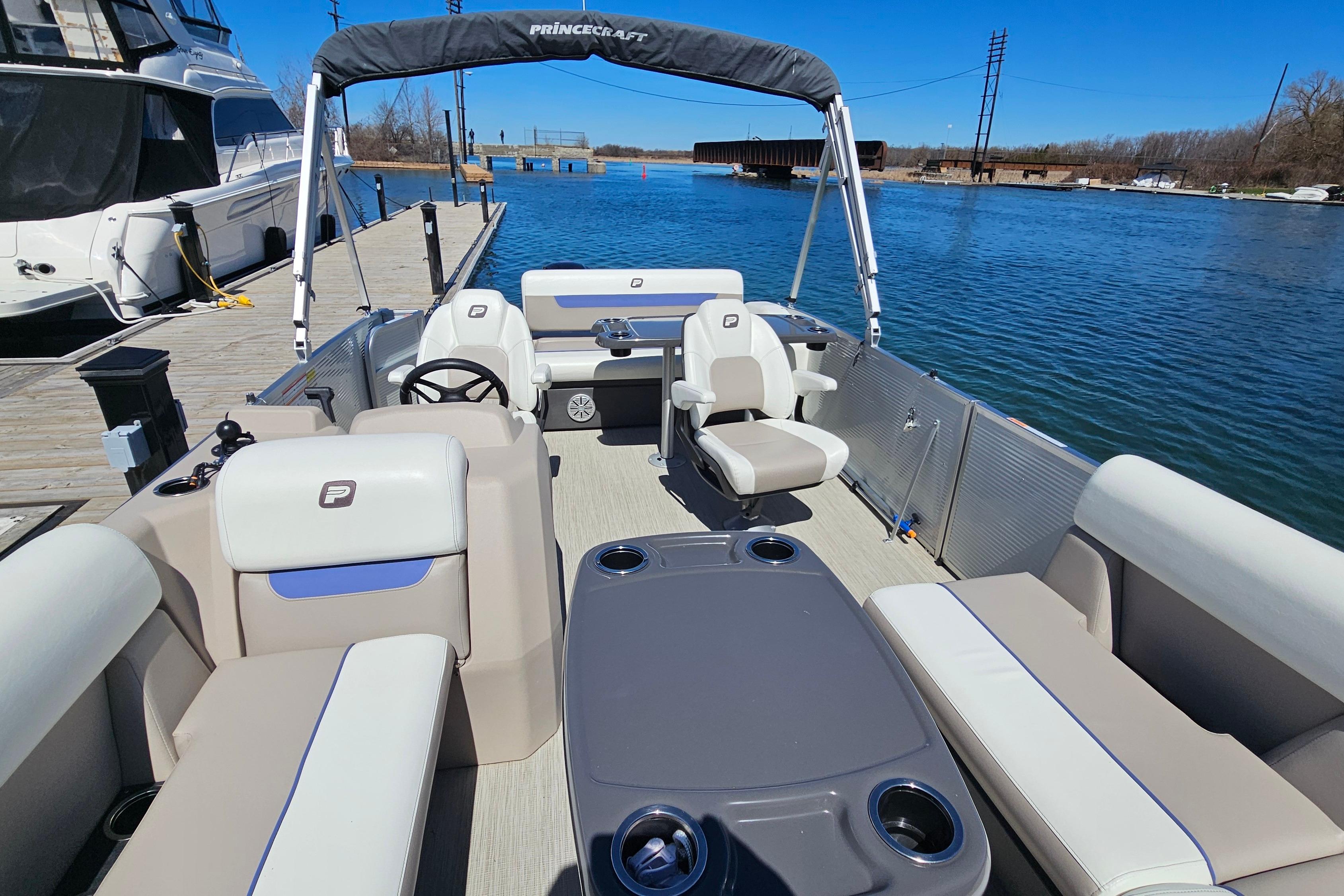 2024 Princecraft Vectra 21 RL pontoon boat docked on a sunny day.