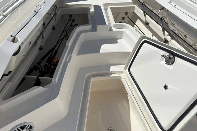 2024 Regulator 24XO boat storage compartments with fishing rod holders.
