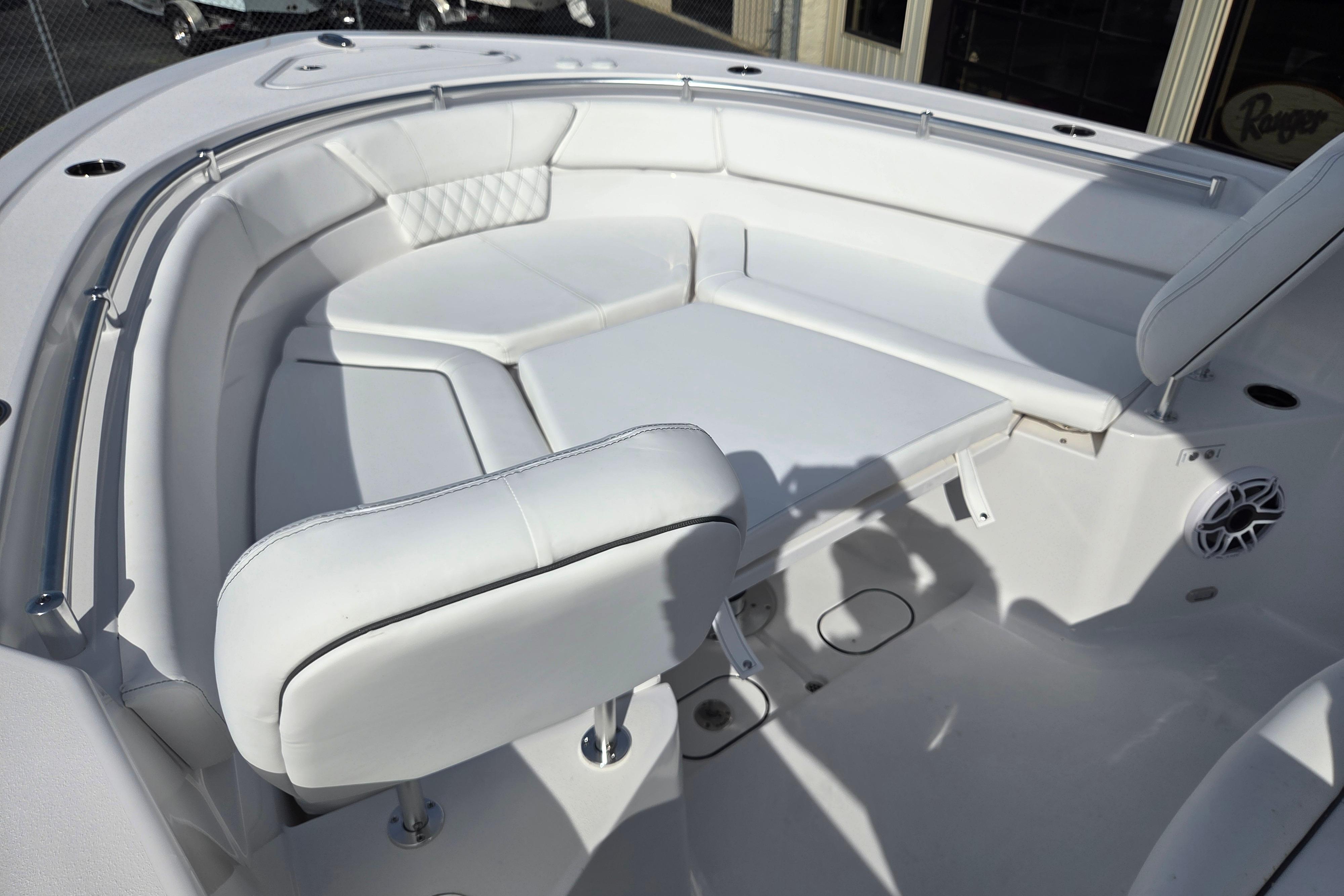 2026 Sportsman Heritage 261 Center Console boat with white cushioned seating area.
