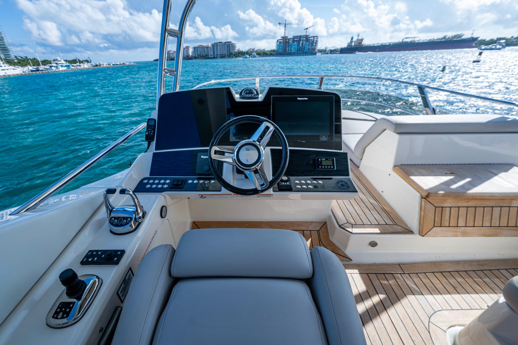 2018 Sea Ray L550 Fly yacht helm with modern controls and ocean view.