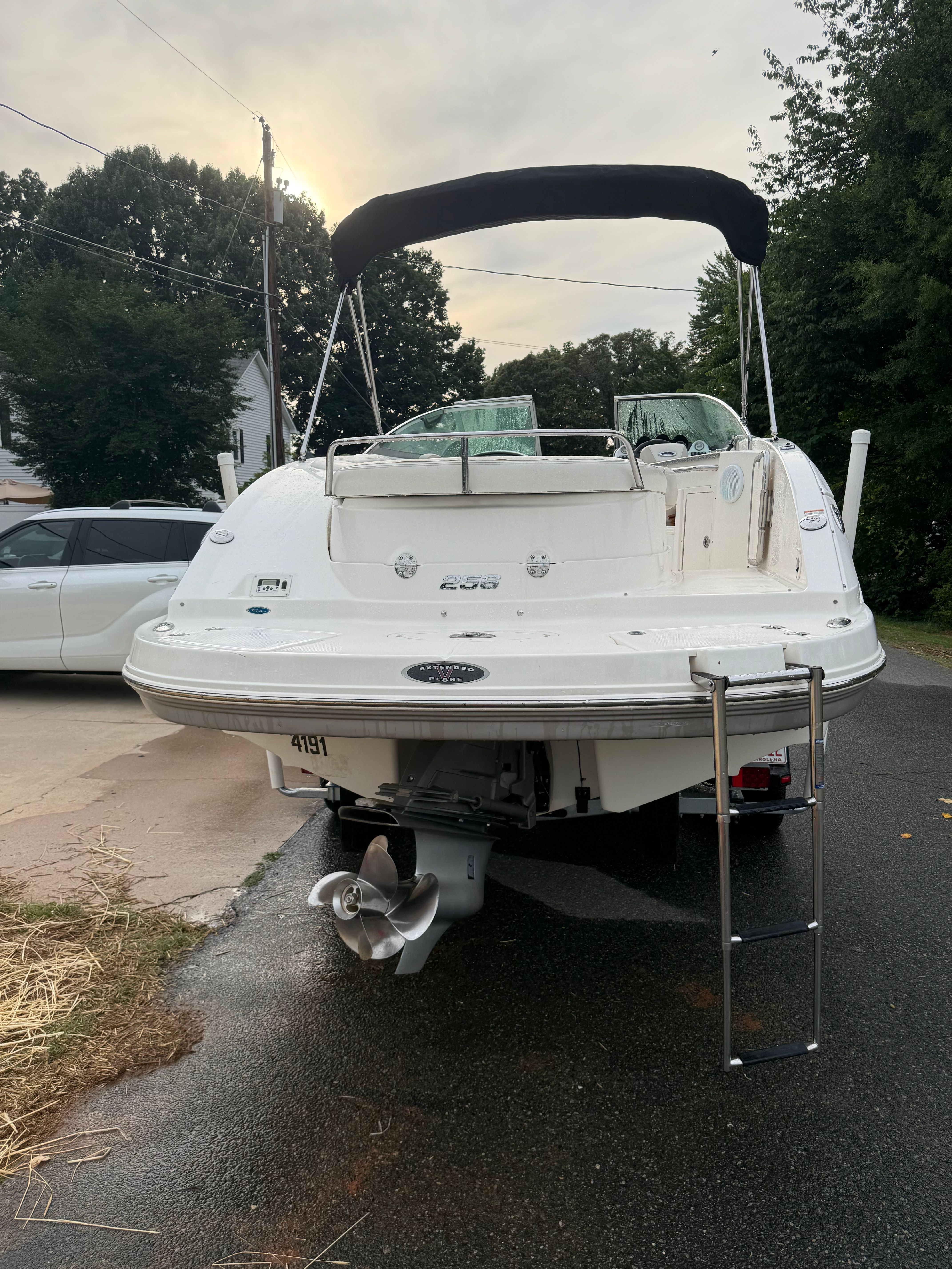 The image shows a white 2007 Chaparral 256 SSX boat with a black Bimini top.