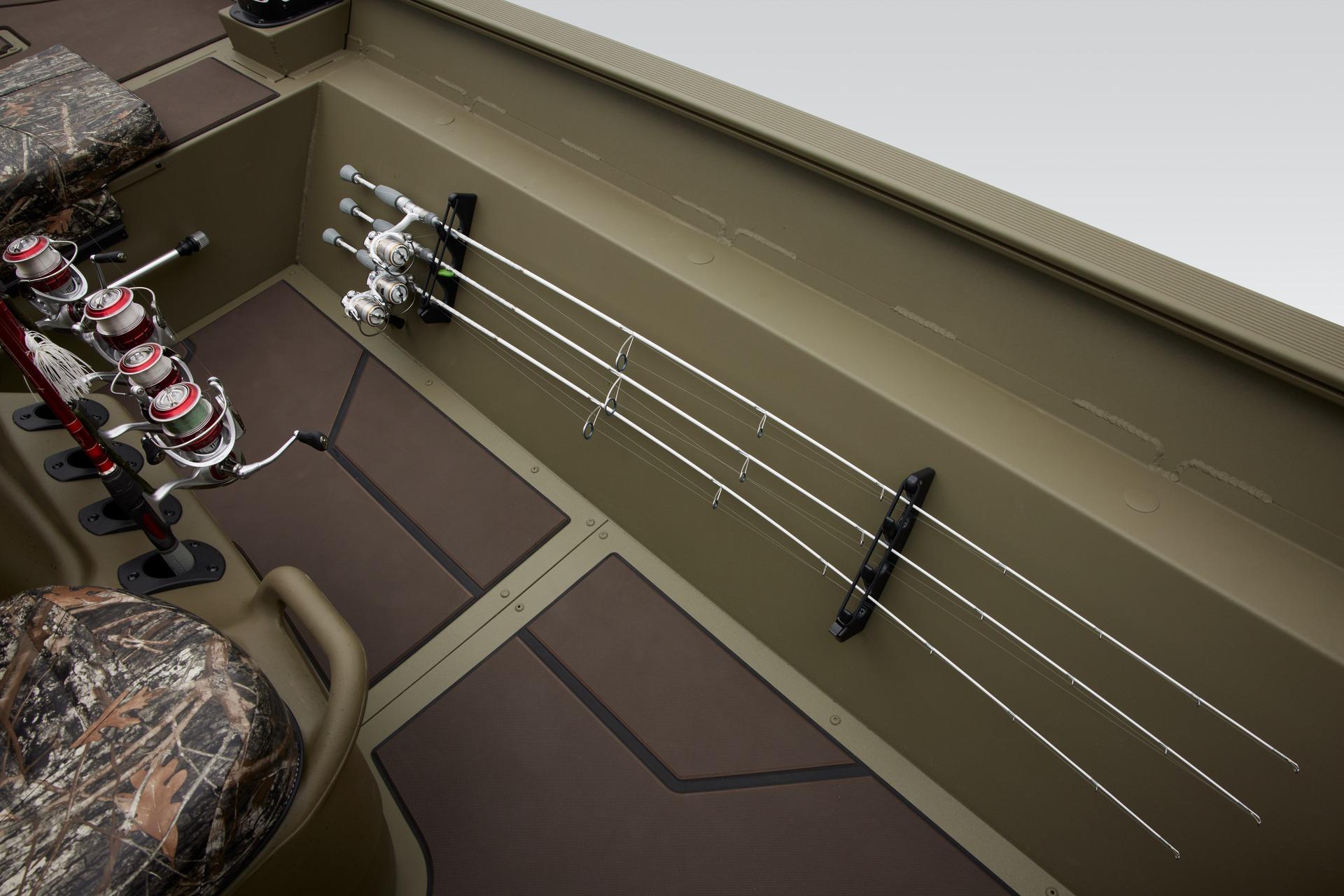 2024 Tracker Grizzly 2072 CC boat interior with fishing rods and camo seats.