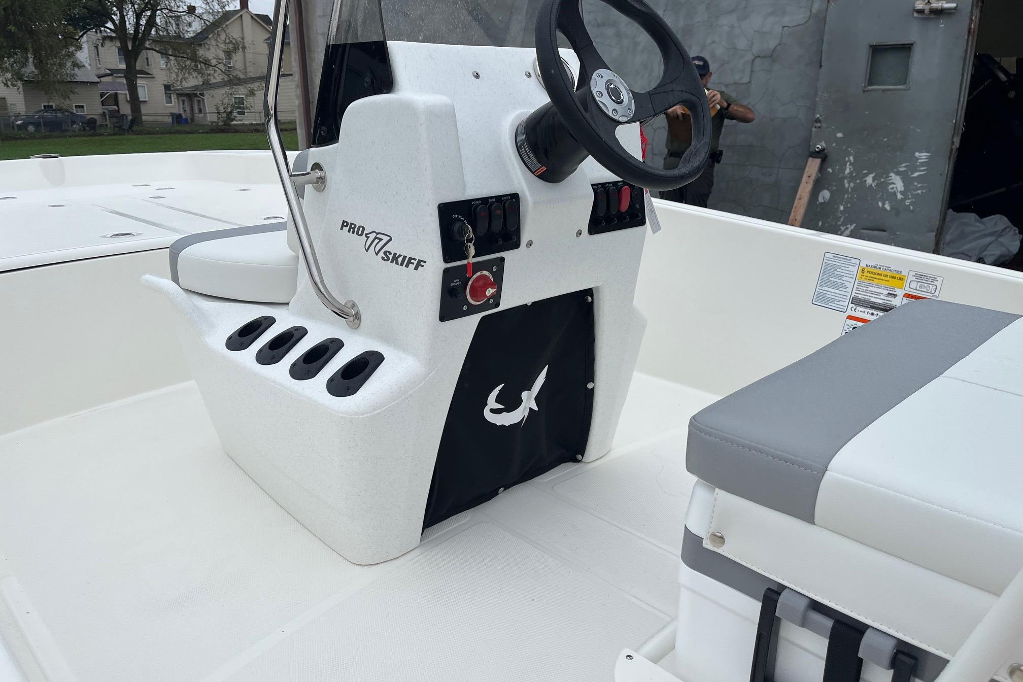 2026 Mako Pro Skiff 17 CC boat interior with steering console and seating.