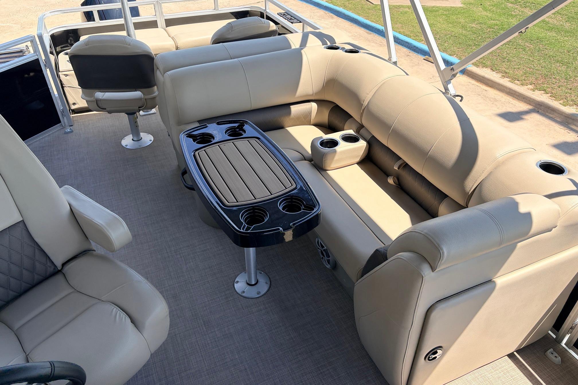 2024 Sun Tracker SportFish 22 XP3 interior with beige seating and table.