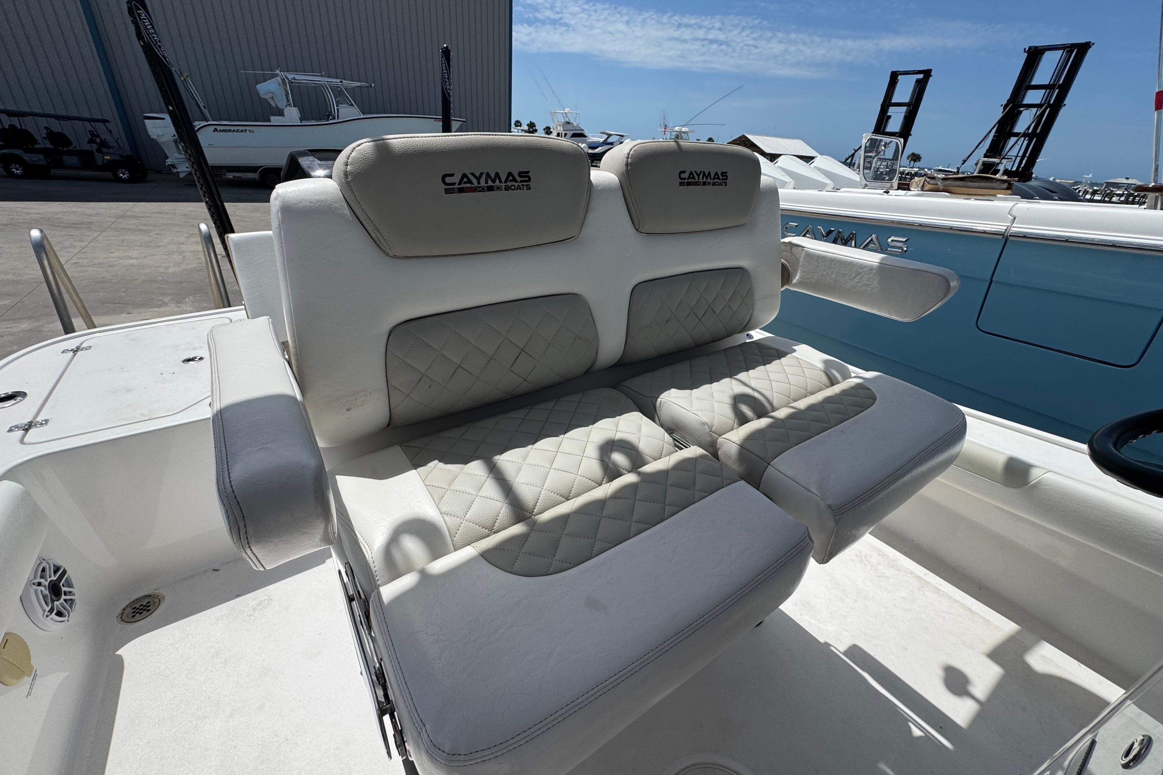 2022 Caymas 26 HB boat with cushioned seating and elegant design.