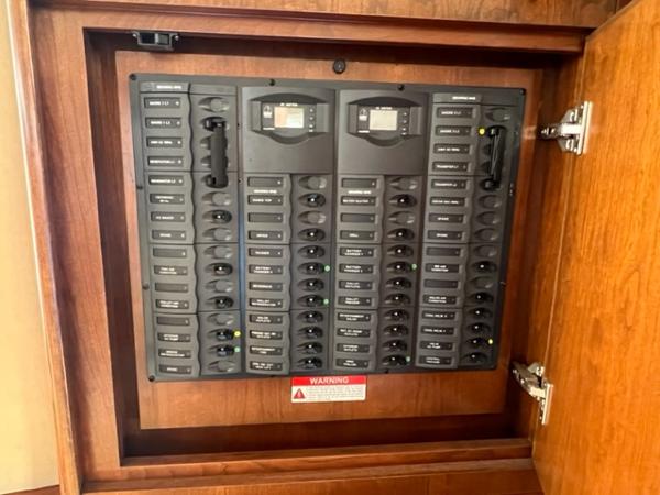 Electrical control panel inside a wooden cabinet, Ovation 52, 2009 model.