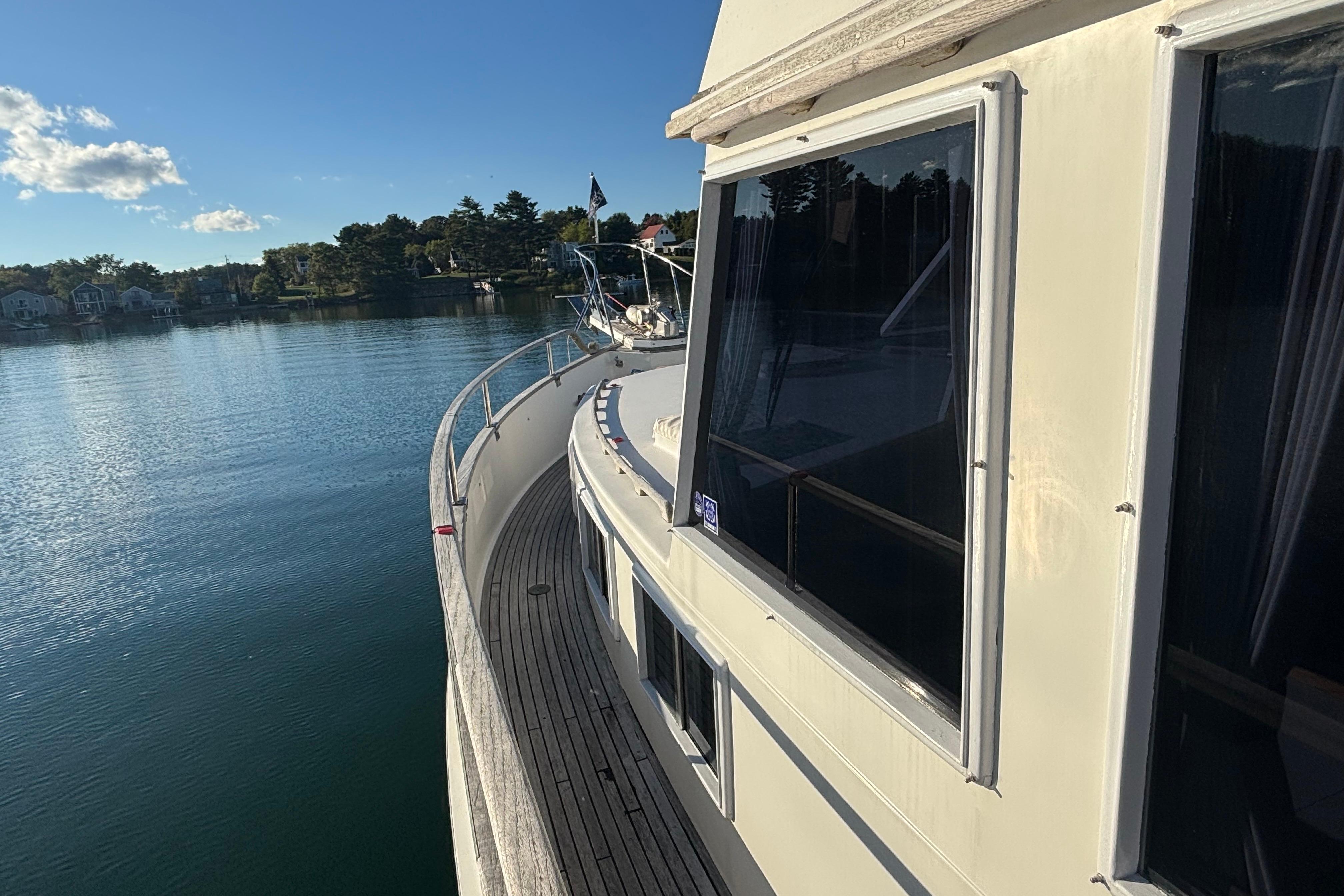1989 Grand Banks 46 Classic yacht on calm water, showcasing elegant design and scenic surroundings.