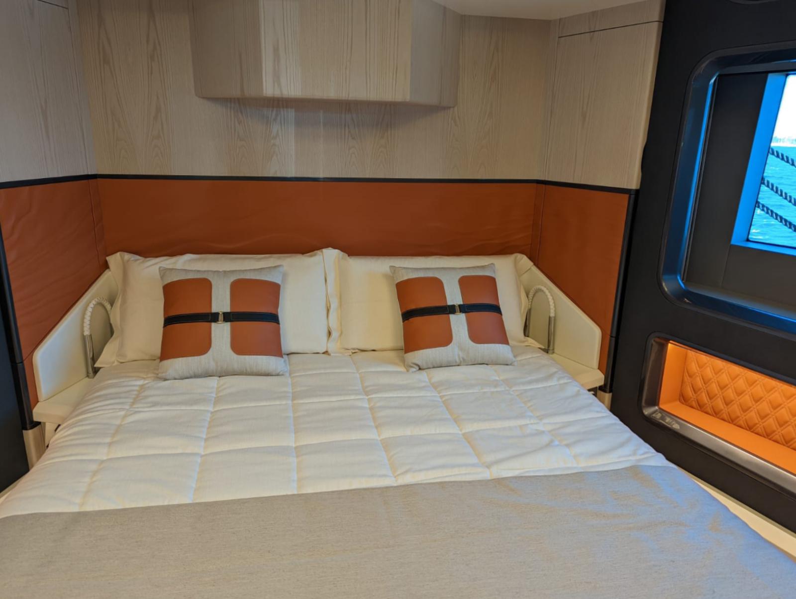Luxurious bedroom interior of 2023 Astondoa 677 Coupe yacht with modern design.