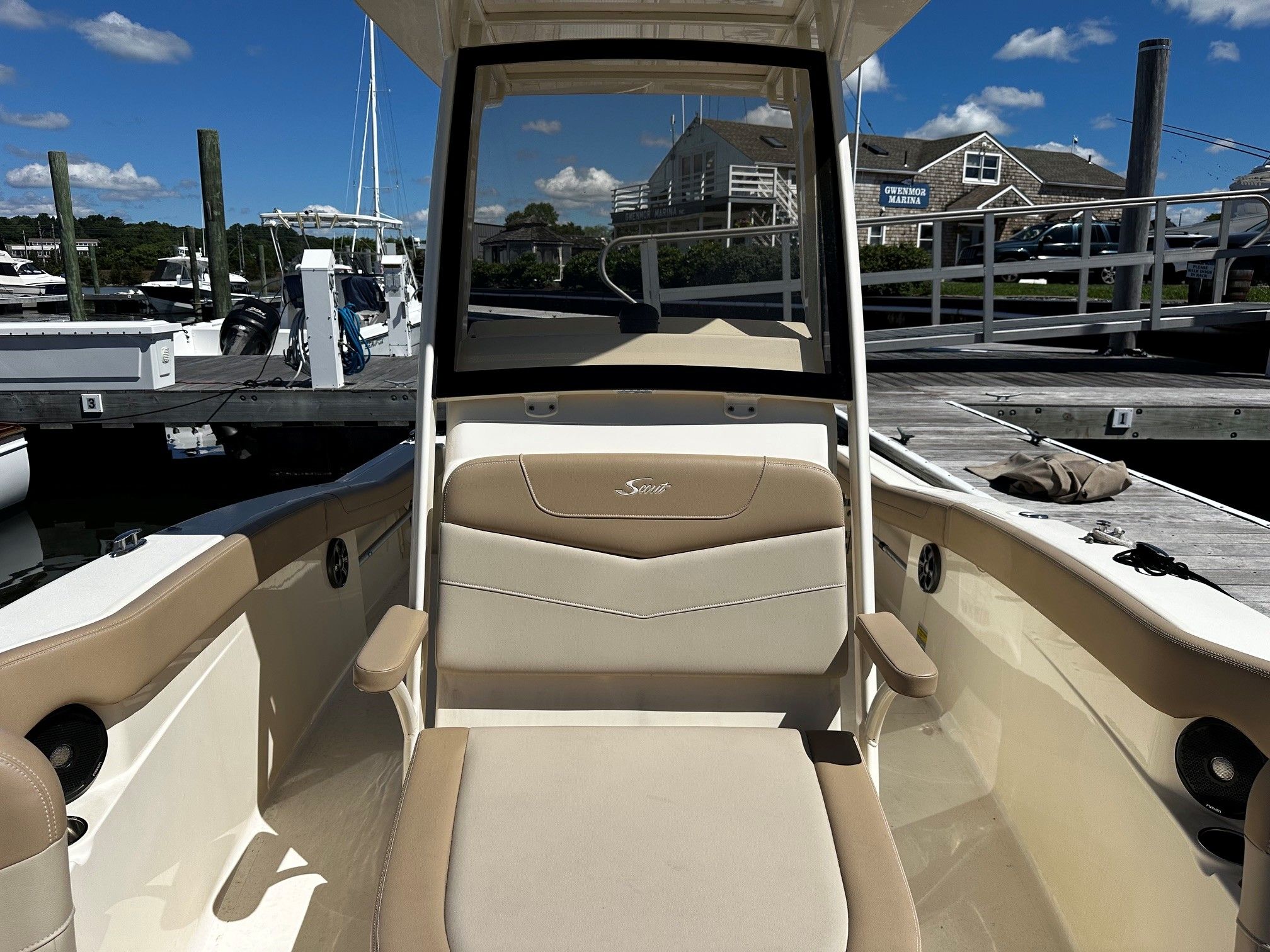 Scout 210XSF 2022 boat docked at marina on sunny day.