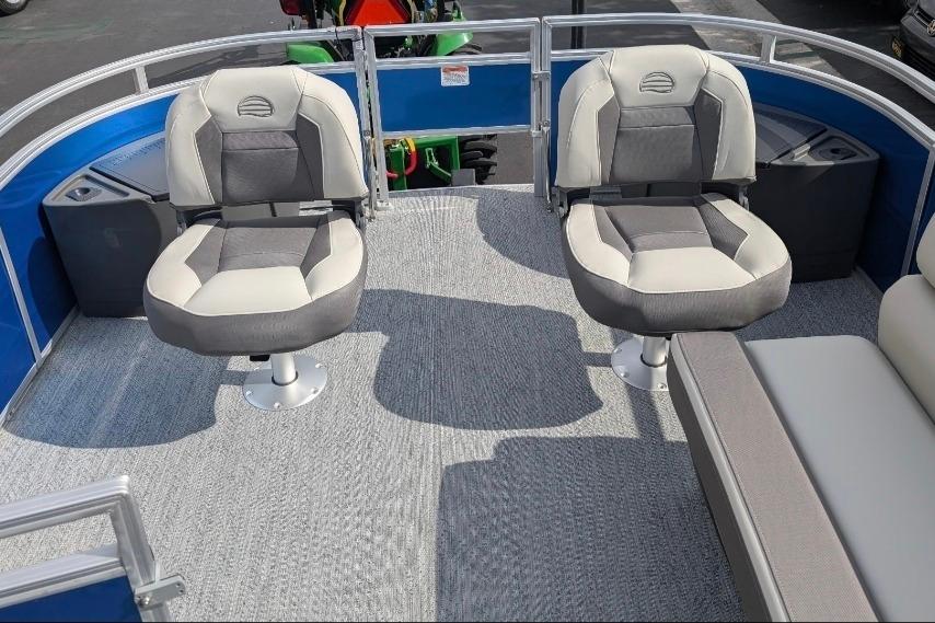 2026 Sun Tracker Fishin' Barge 20 DLX interior with two swivel seats and carpeted flooring.