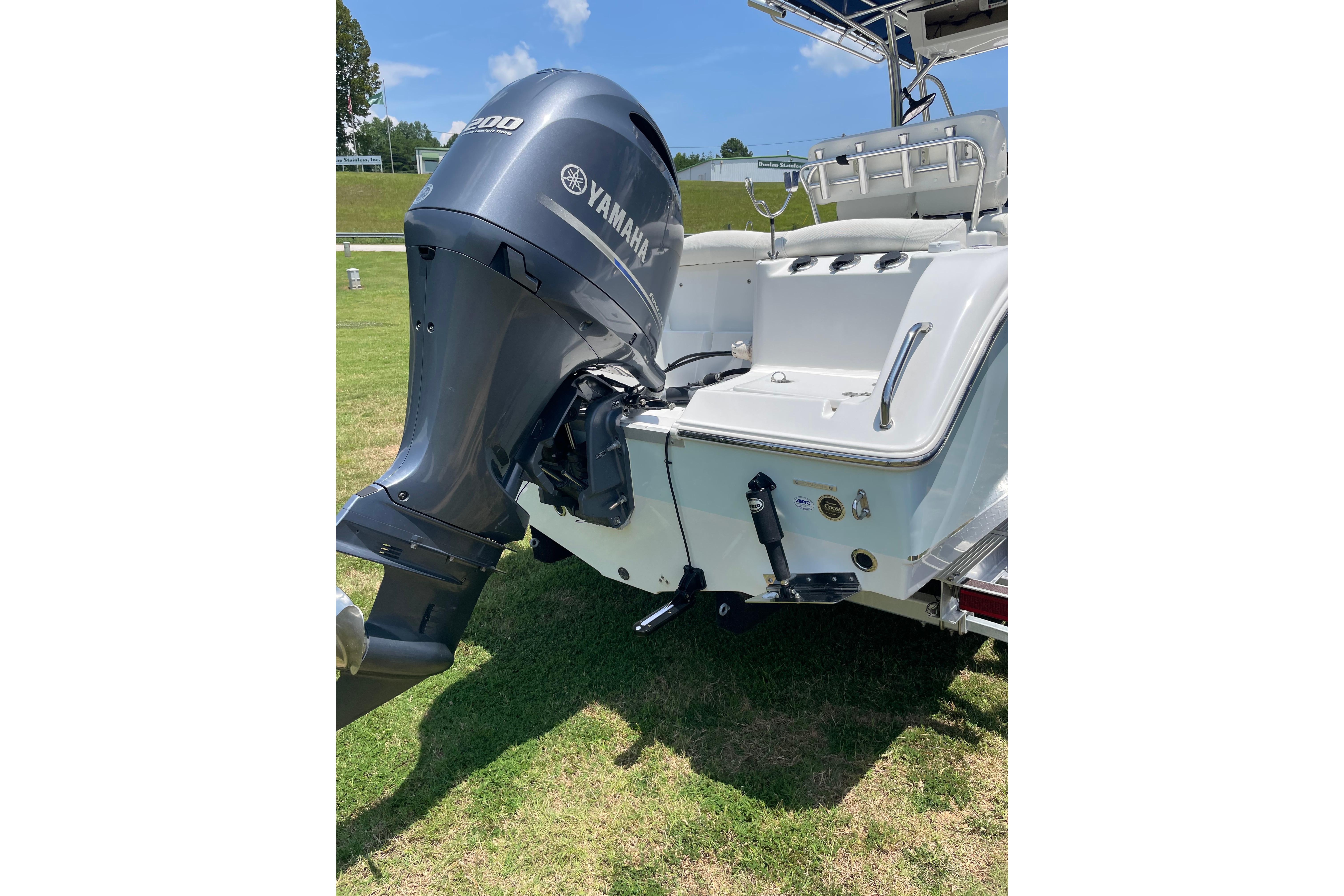 2018 Sea Hunt Ultra 234 boat with Yamaha outboard motor on grassy area.