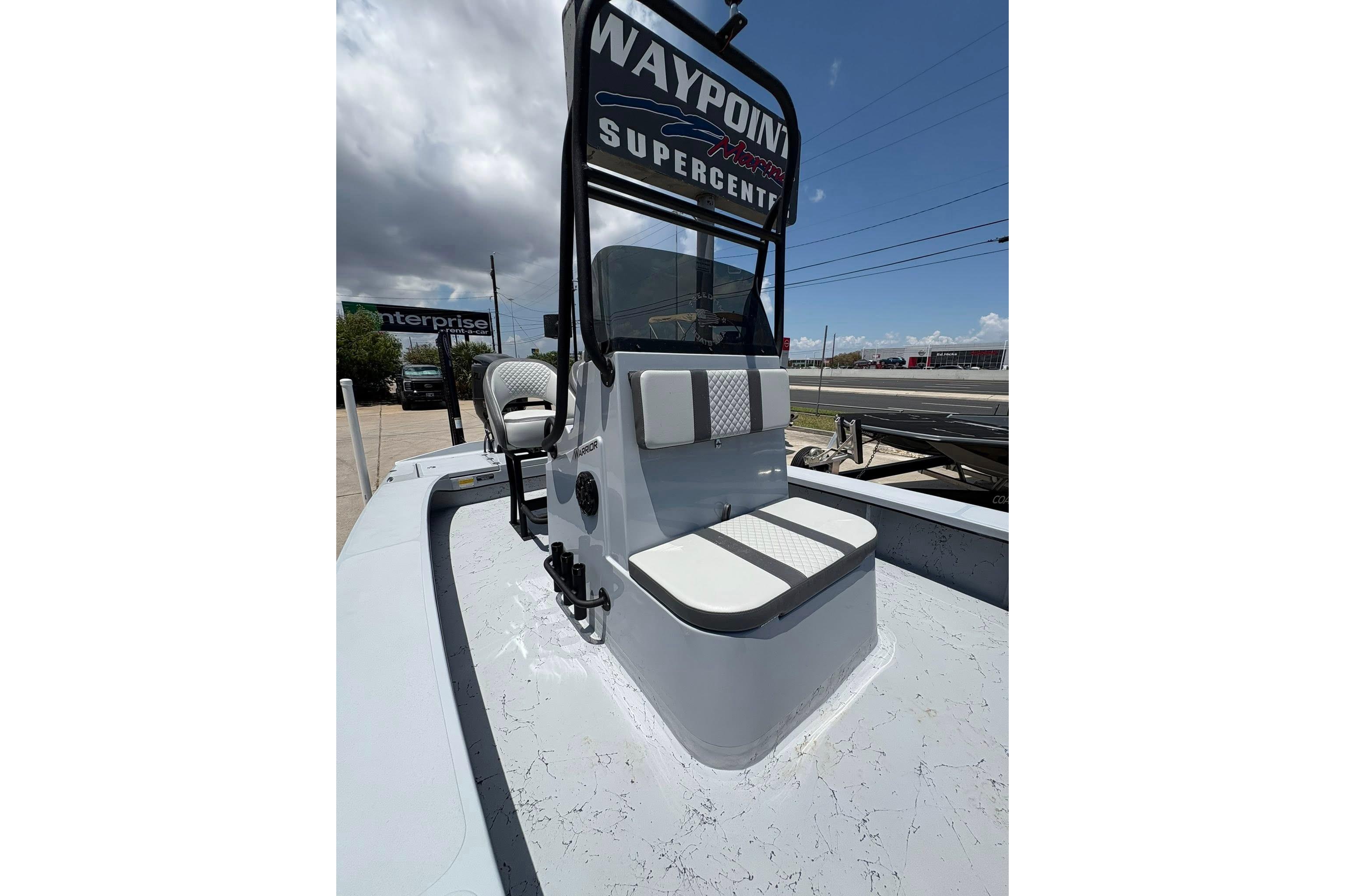 2026 Freedom Boats 23' Warrior with seating, displayed outdoors under cloudy sky.