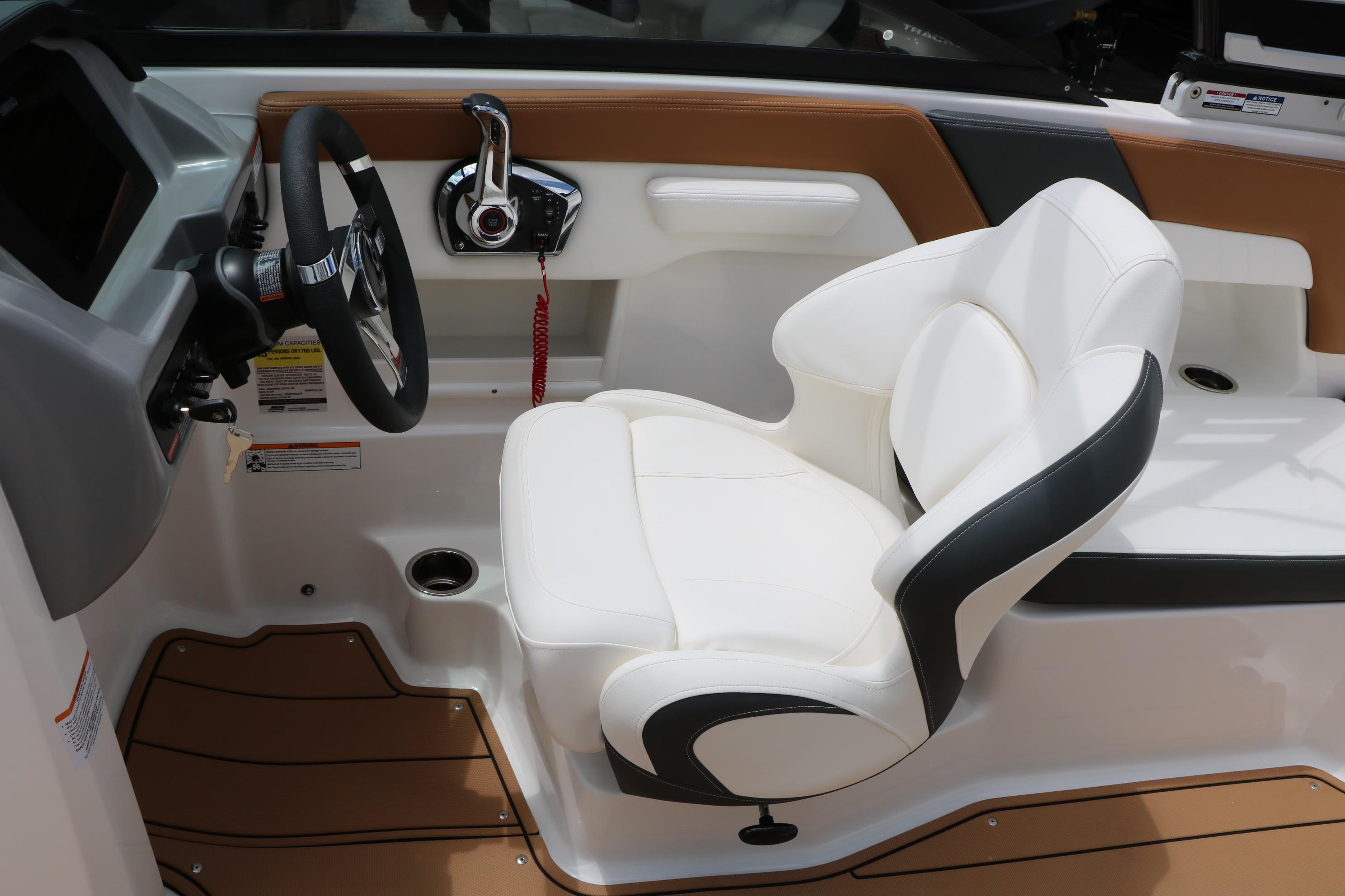 2025 Chaparral 23 SSi boat interior with white captain's seat and modern steering console.
