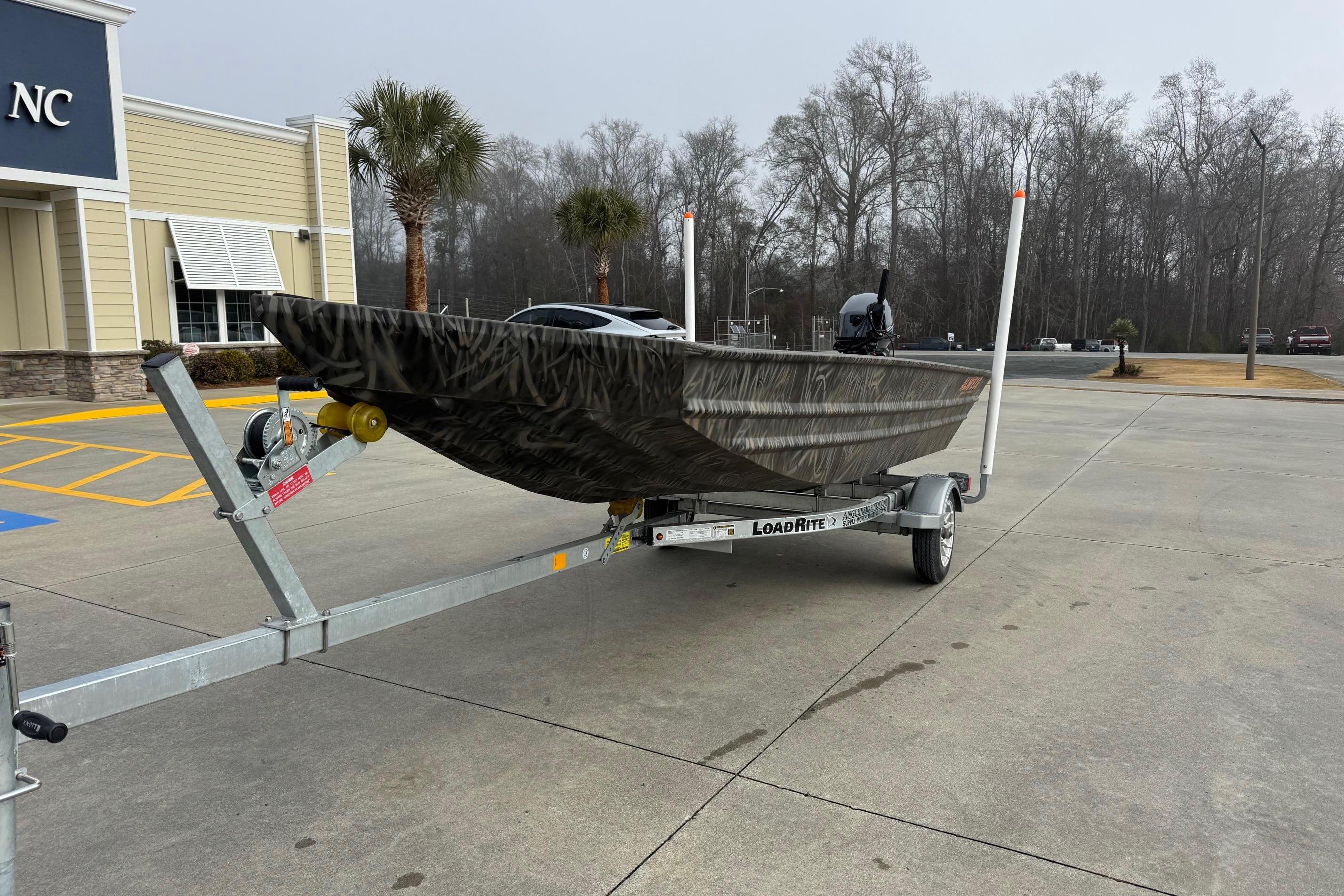 2026 Alweld 1548VV Marsh boat on trailer in parking lot, overcast day.