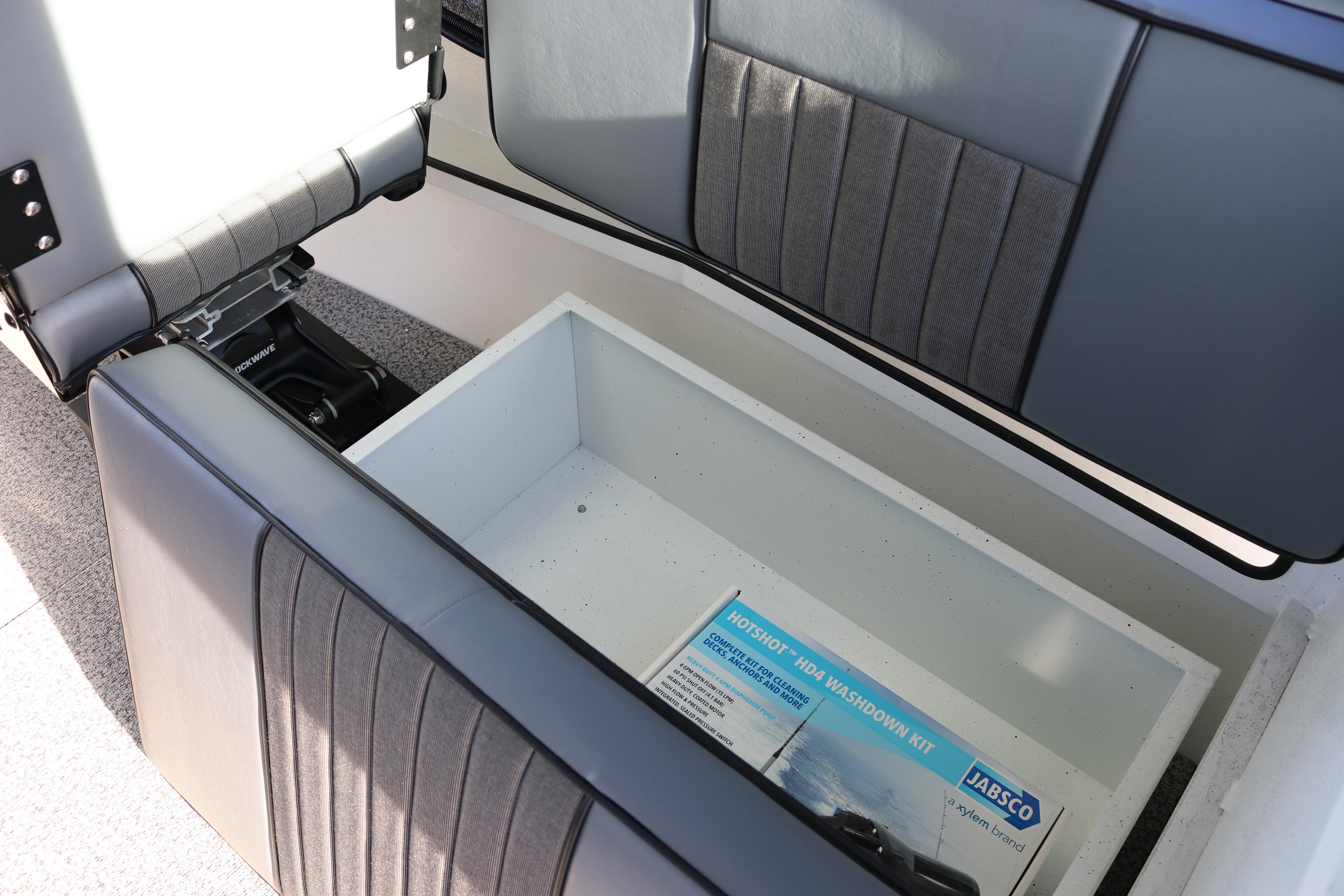 2026 Alumaweld Intruder Outboard 22 boat storage compartment with Jabsco washdown kit.