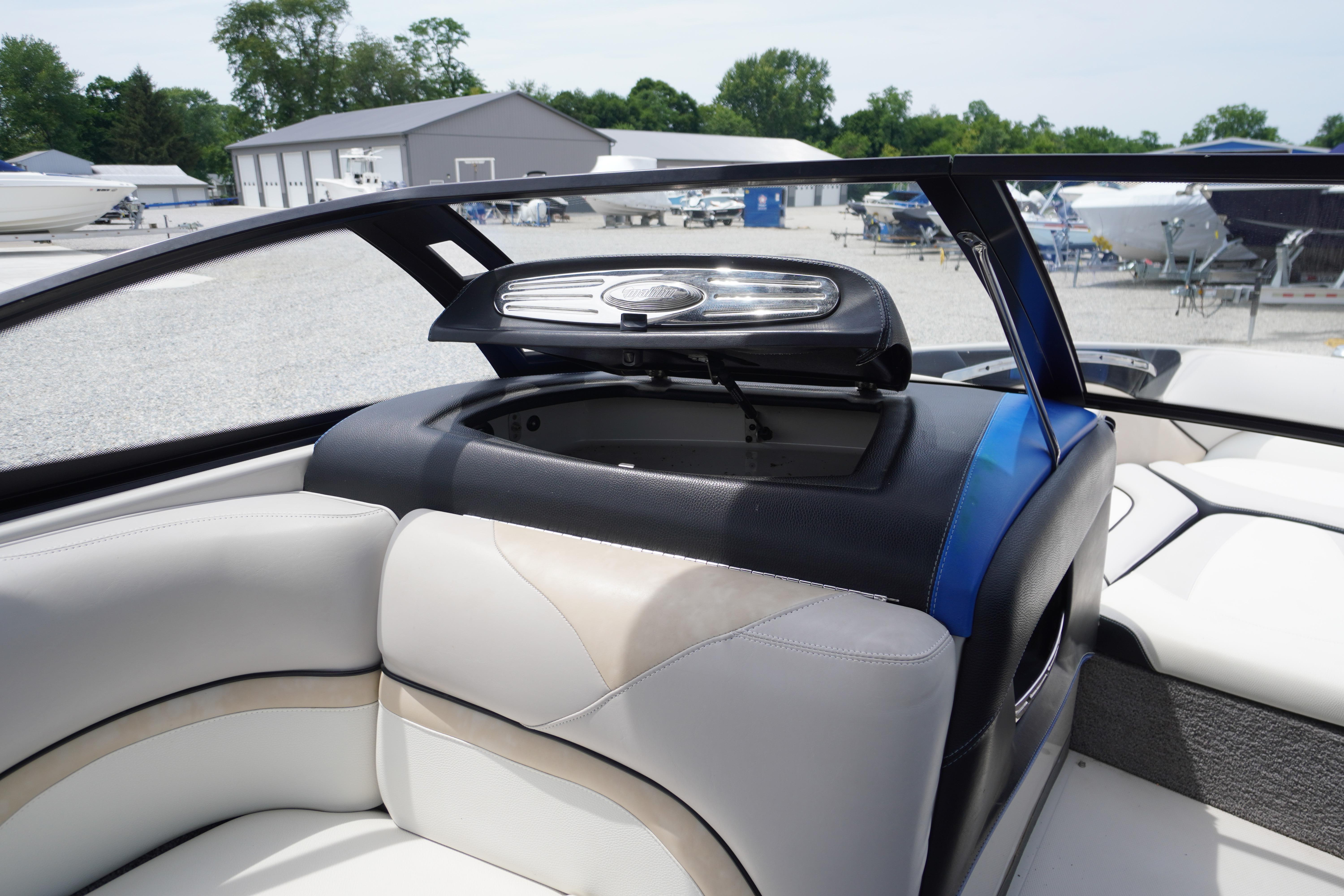 2011 Malibu Wakesetter 21 VLX interior with open storage compartment, showcasing sleek design.
