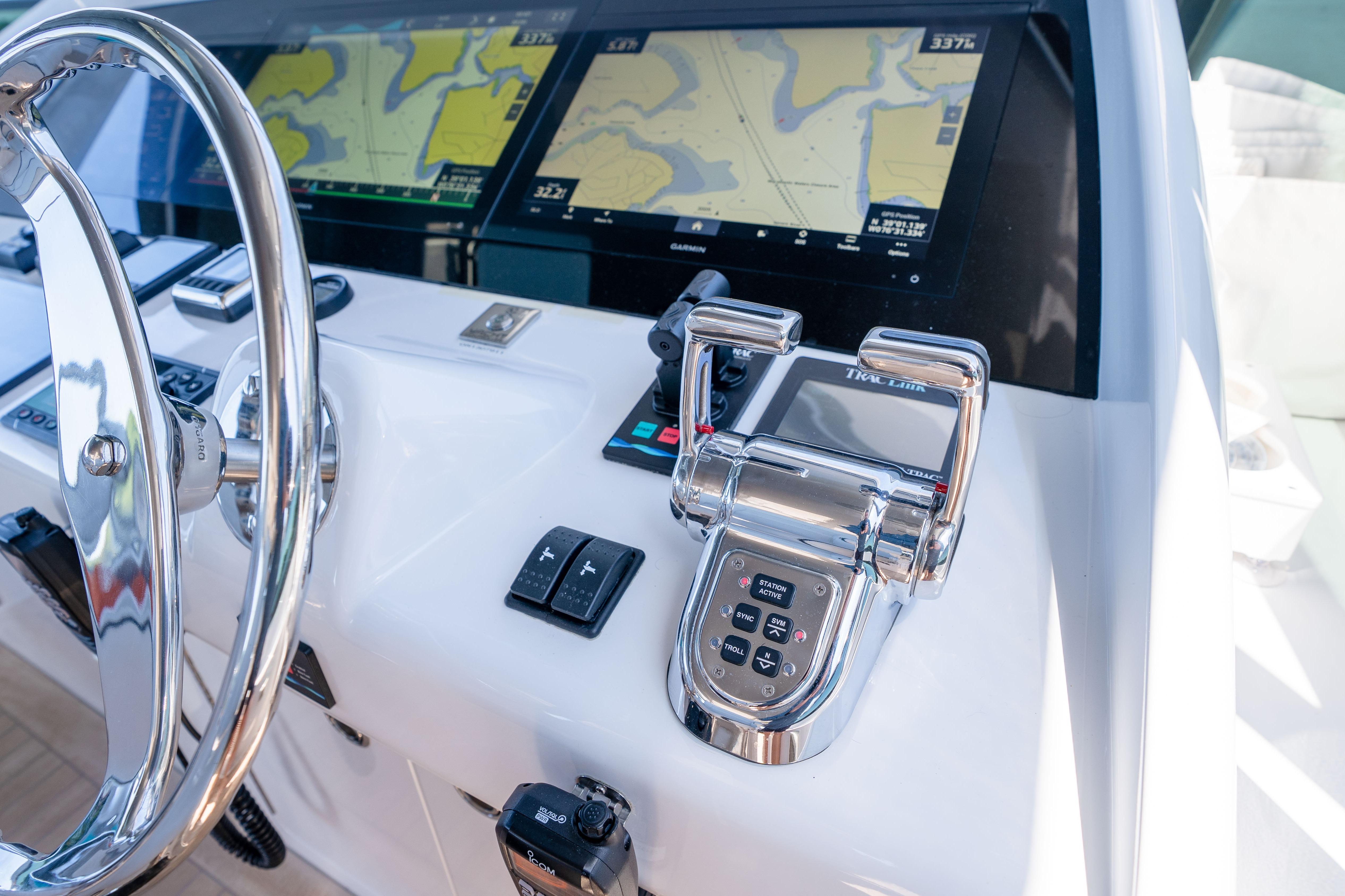 Helm of 2021 Hatteras M75 Panacera yacht with navigation screens and controls.