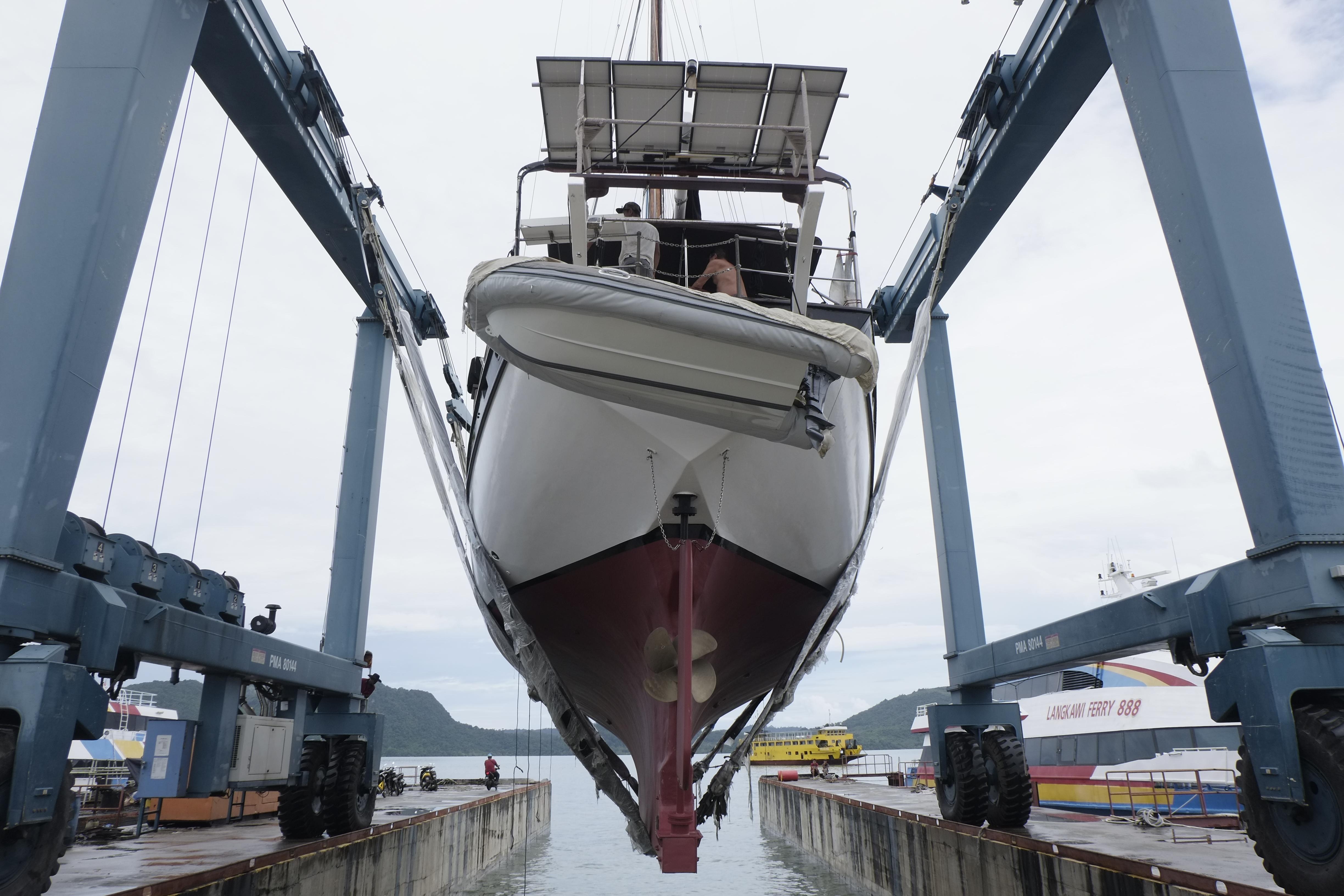 Custom Bud Macintosh schooner 2006 in dry dock, lifted by crane for maintenance.