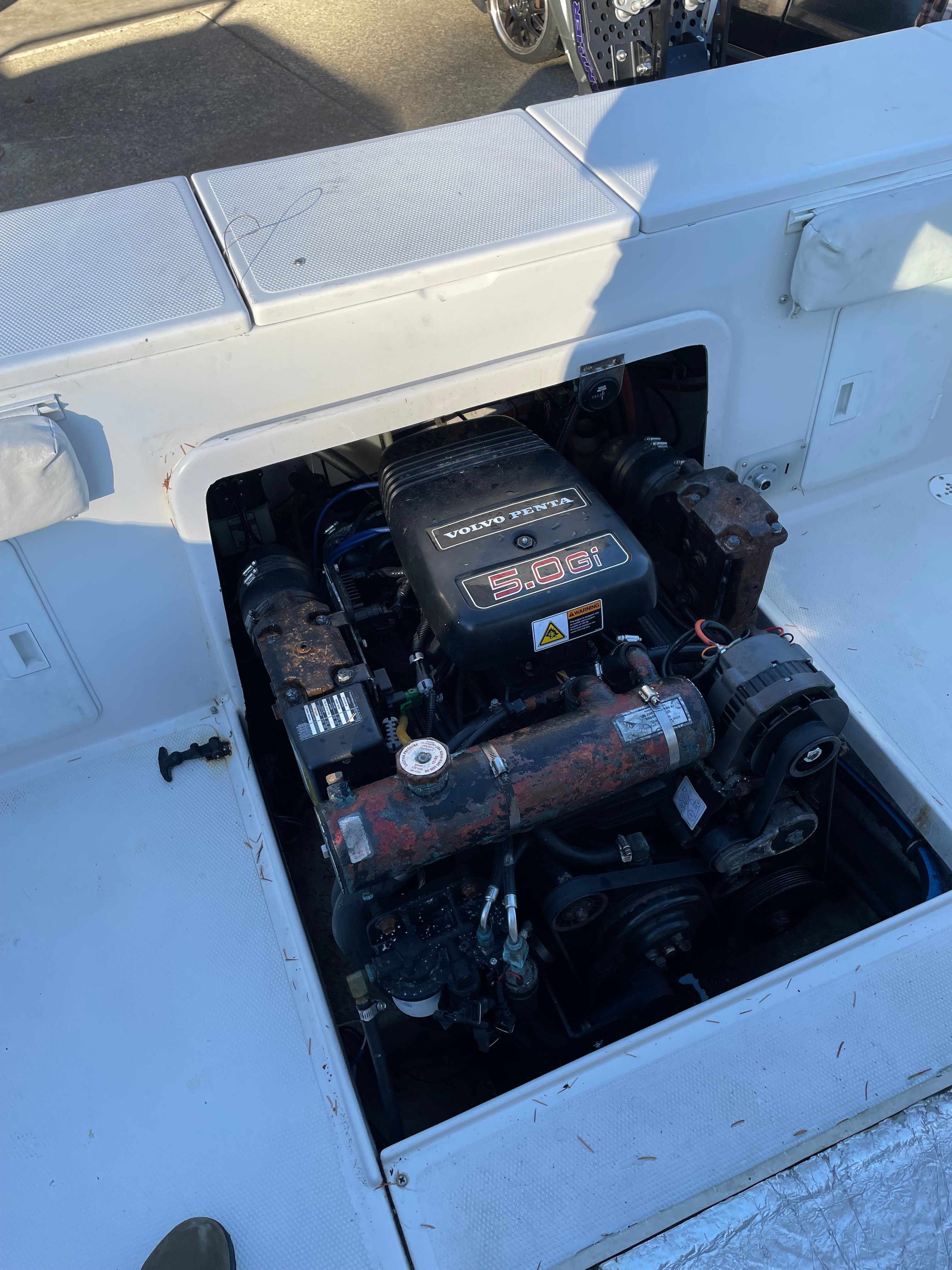 An open engine compartment of a 2001 Bluewater 2100 Sport Fisher with a Volvo Penta engine.