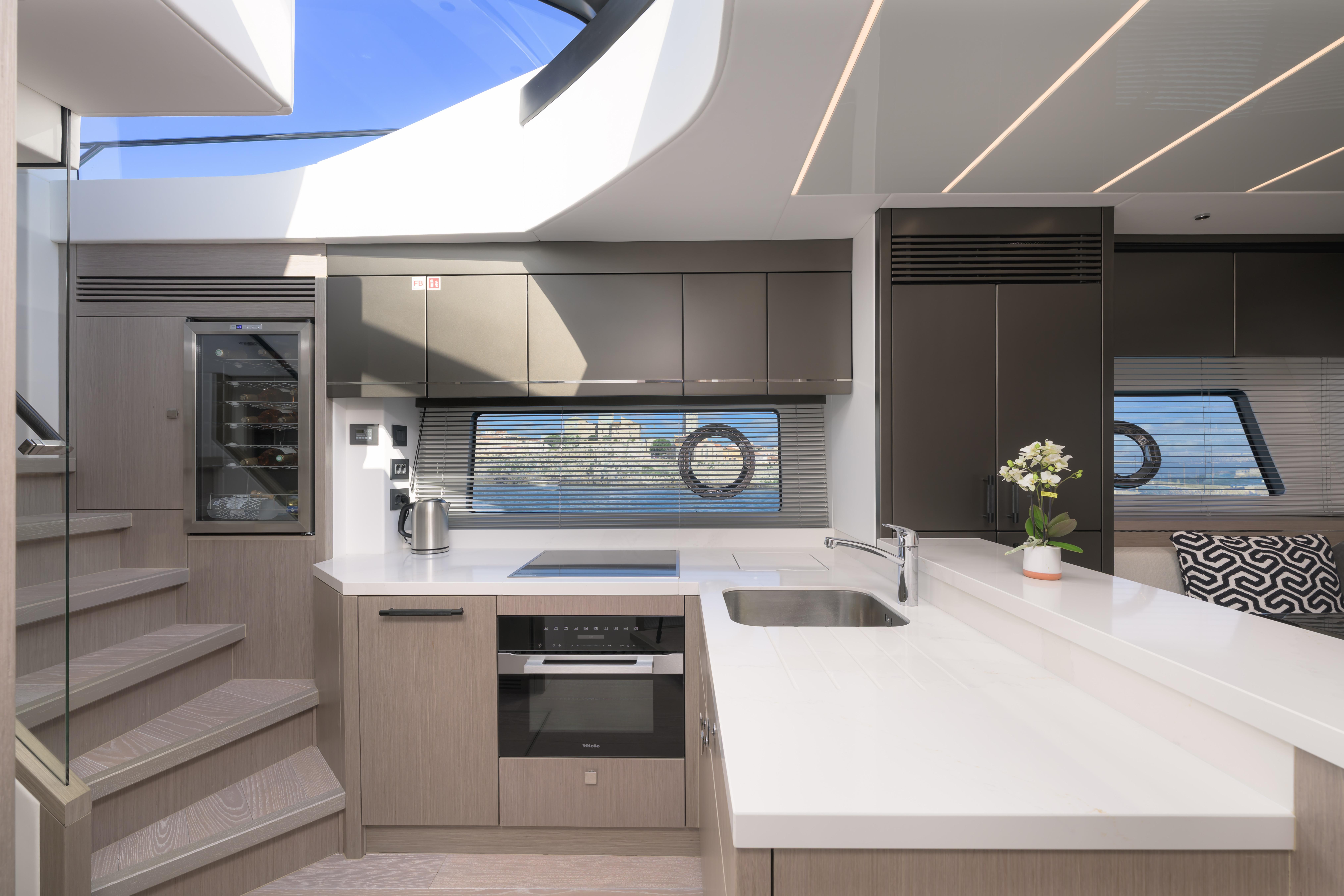 Modern kitchen interior of 2024 Sunseeker 75 Sport Yacht with sleek design and natural lighting.