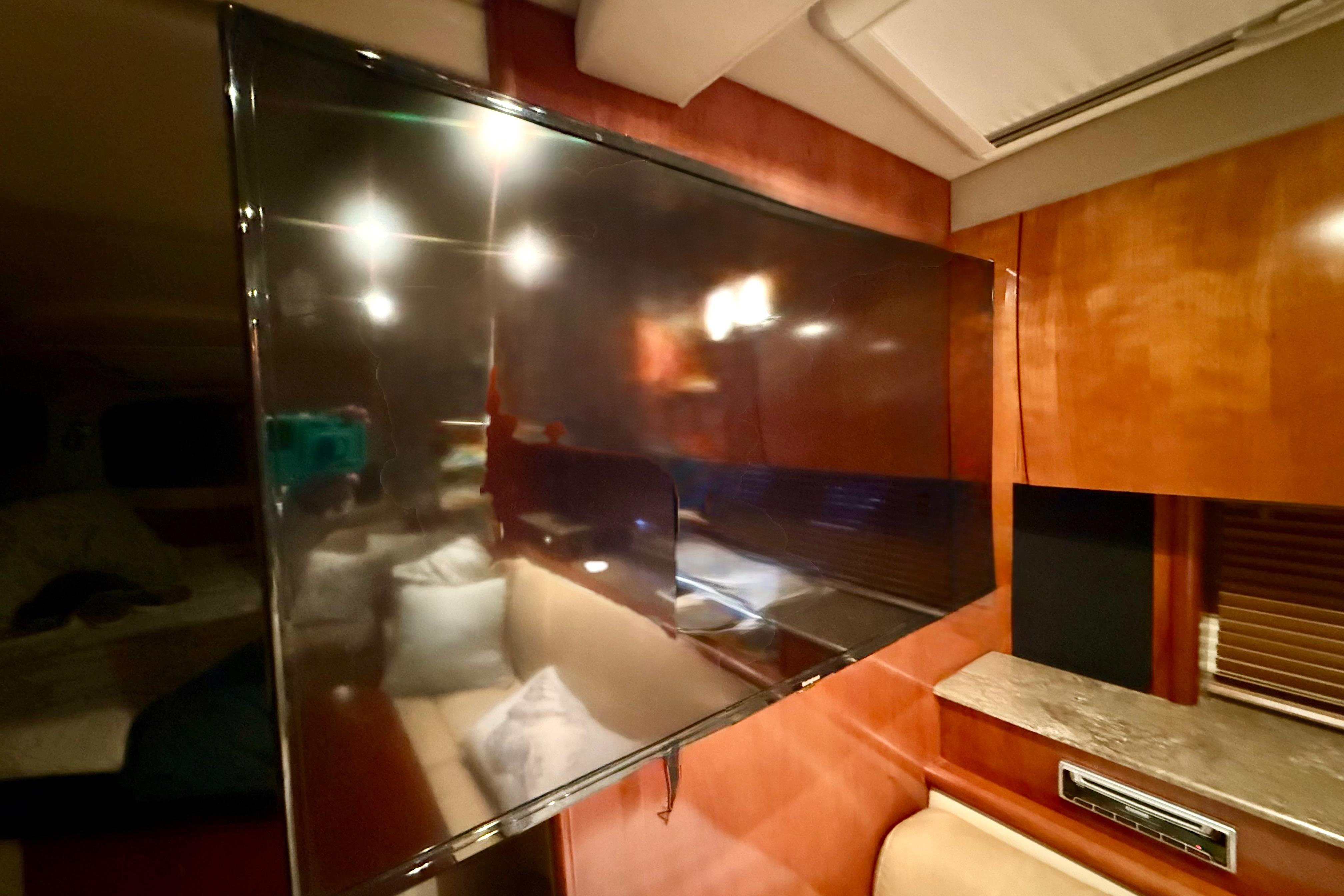 Interior of 2011 Cruisers Yachts 390 Sports Coupe with mounted flat-screen TV.