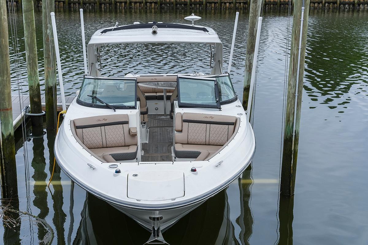 2018 Sea Ray SLX 350 boat docked in calm waters, showcasing luxurious seating.
