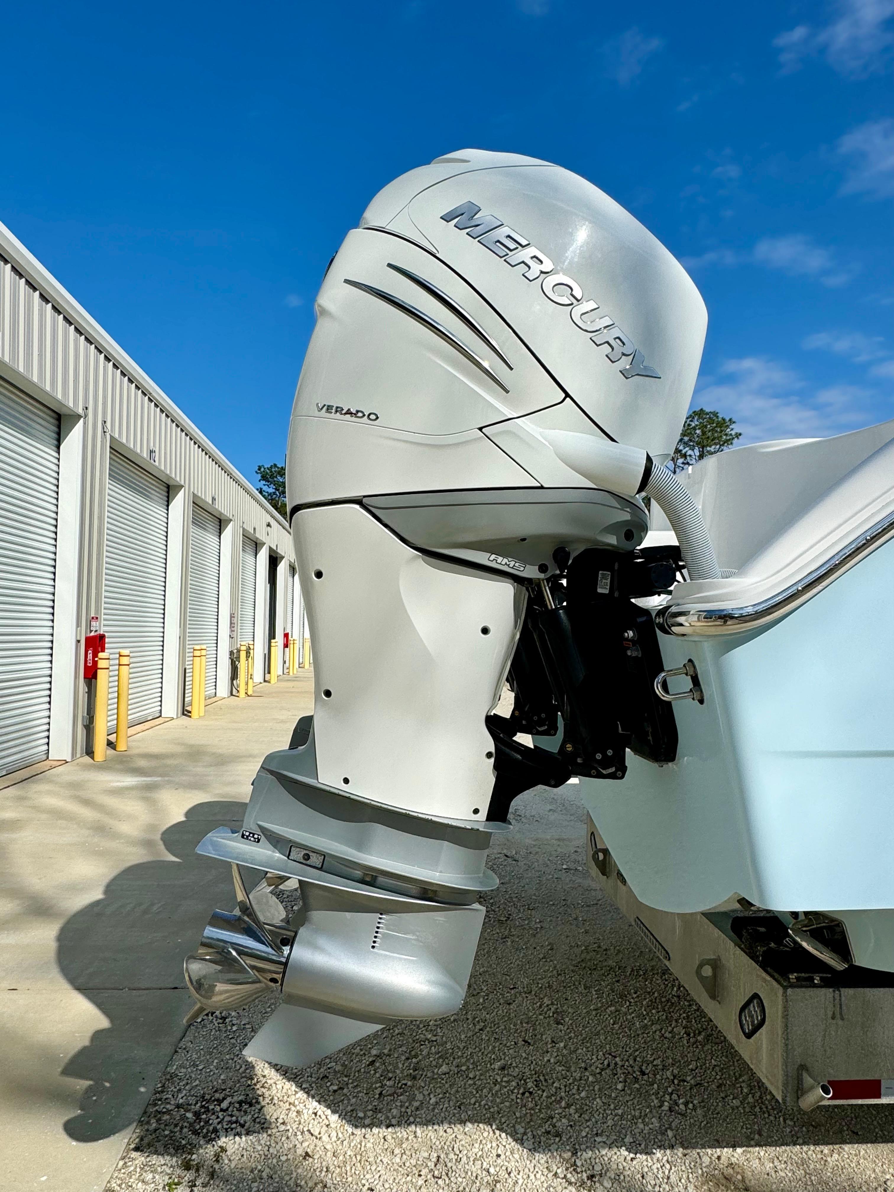 Mercury Verado outboard motor on 2020 Invincible 37 Catamaran, parked near storage units.
