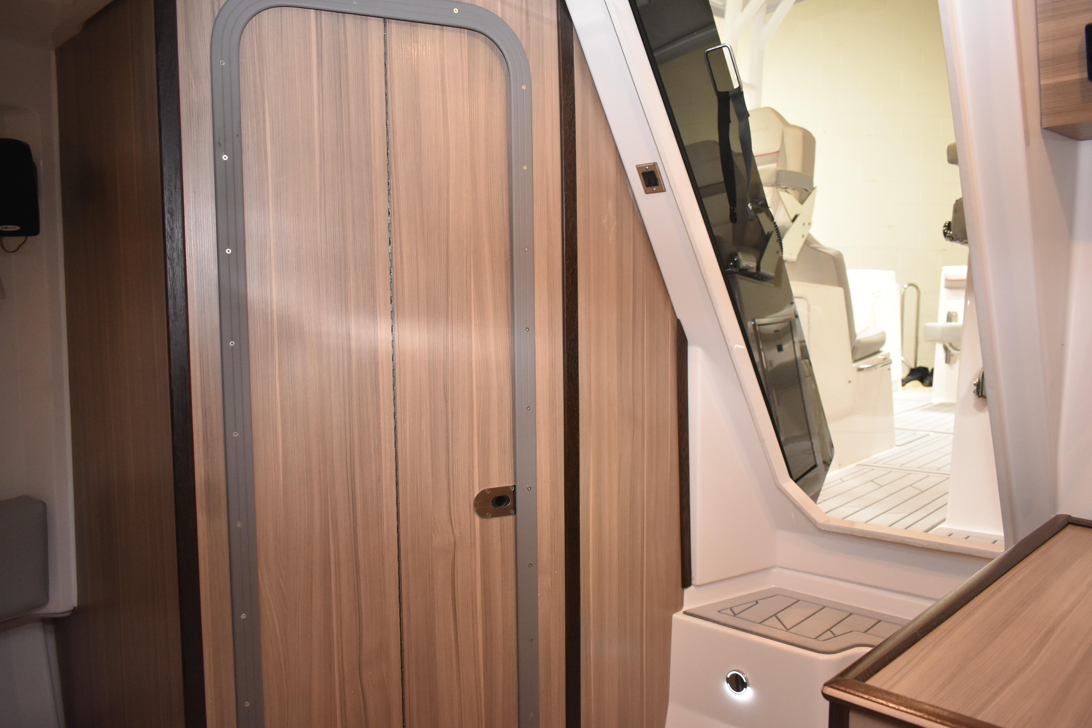 Interior of 2025 Solara S-310 CW boat, featuring sleek wooden door and modern design.