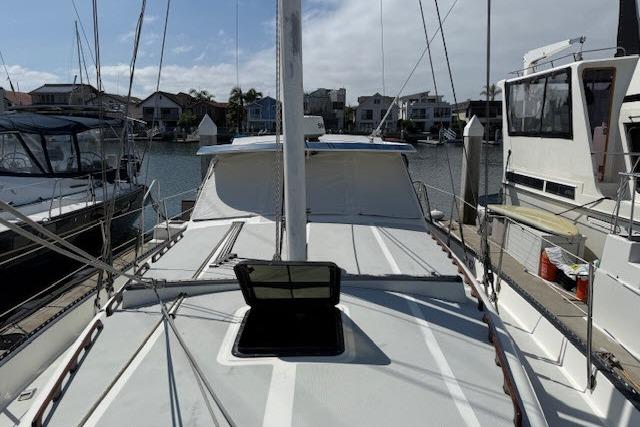 1982 Lancer 45 Motorsailer docked in a marina, surrounded by other boats.