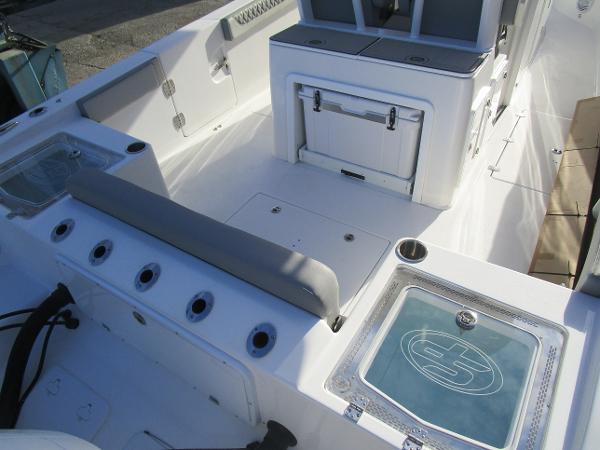 2024 Sea Pro 322 Offshore boat interior with seating and storage compartments.
