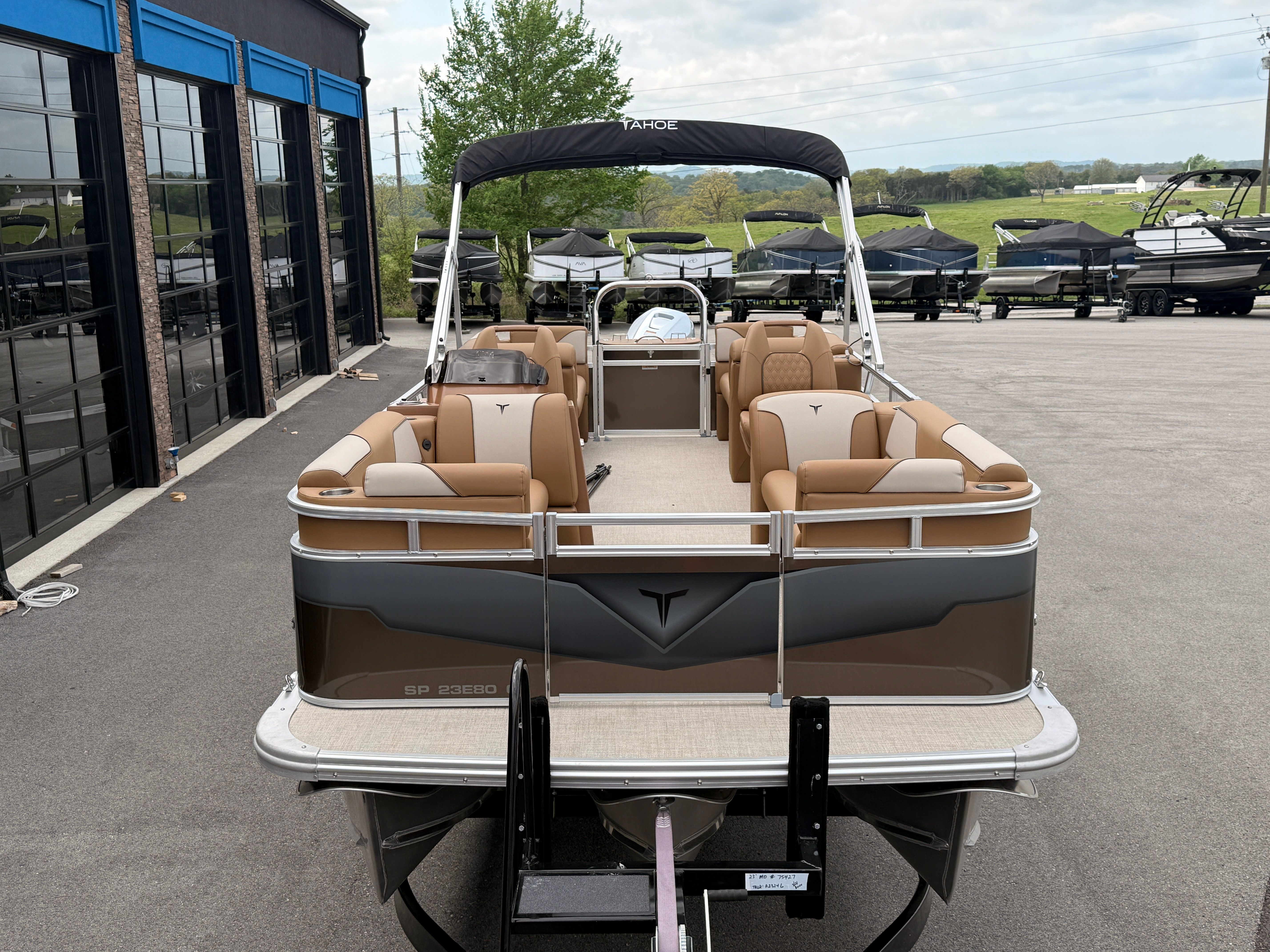 2026 Tahoe 2380 Sport Quad Lounger pontoon boat on parking lot.