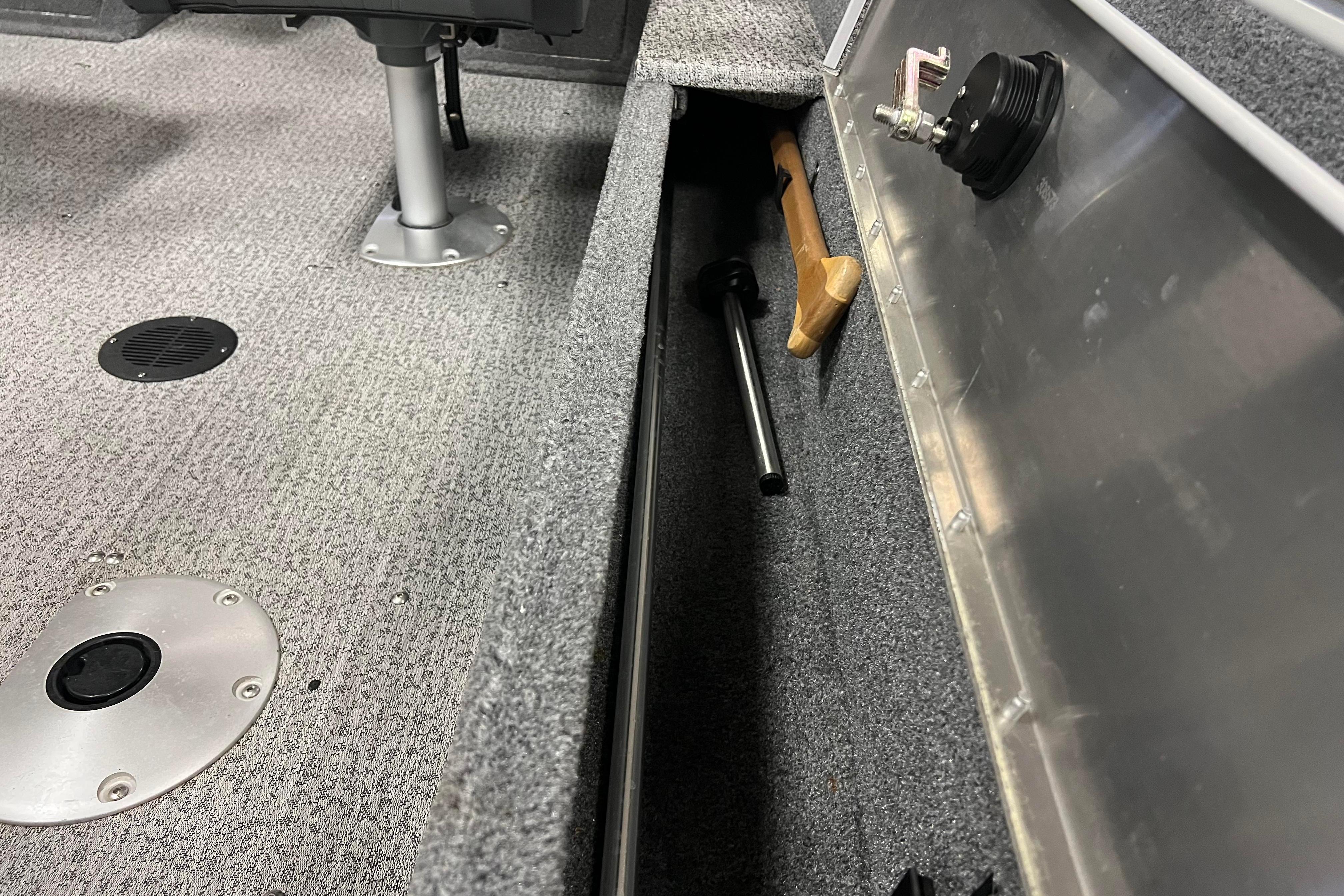 2022 Tracker Pro Guide V-16 WT boat interior with storage compartment and tools.