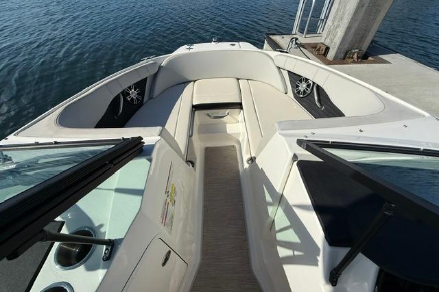 2022 Sea Ray SPX 210 Outboard boat interior with seating, docked by water.