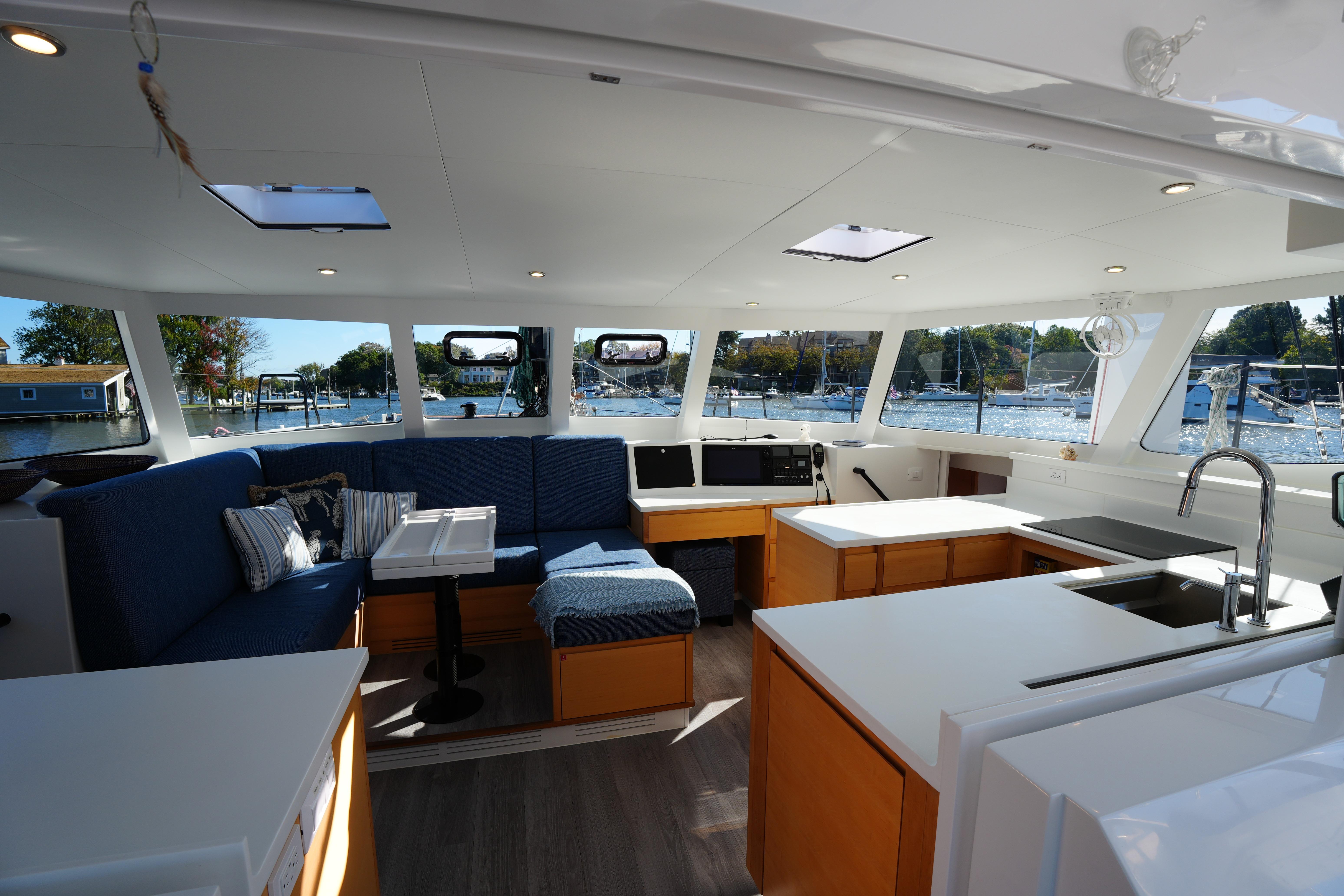 Luxurious interior of 2024 Balance 442 yacht with modern kitchen and seating area.