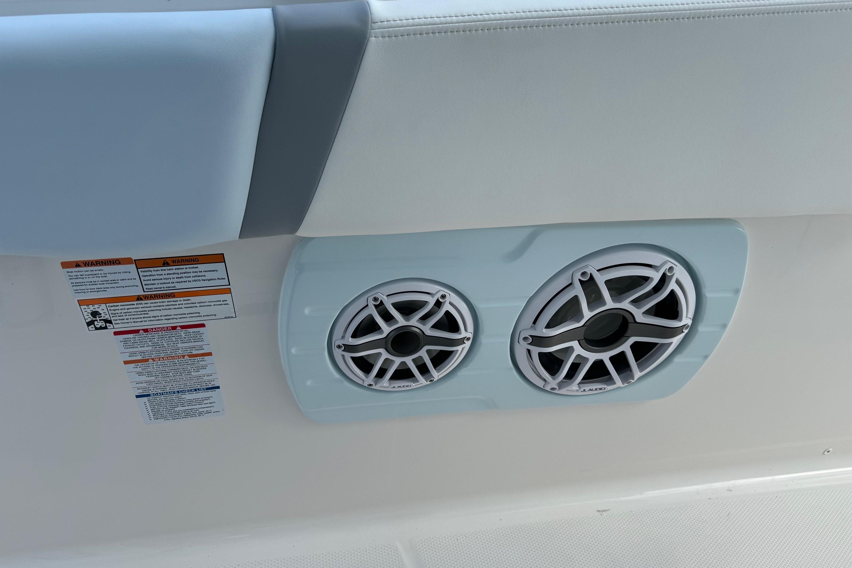 2025 Robalo R360 Center Console boat speakers and warning labels.