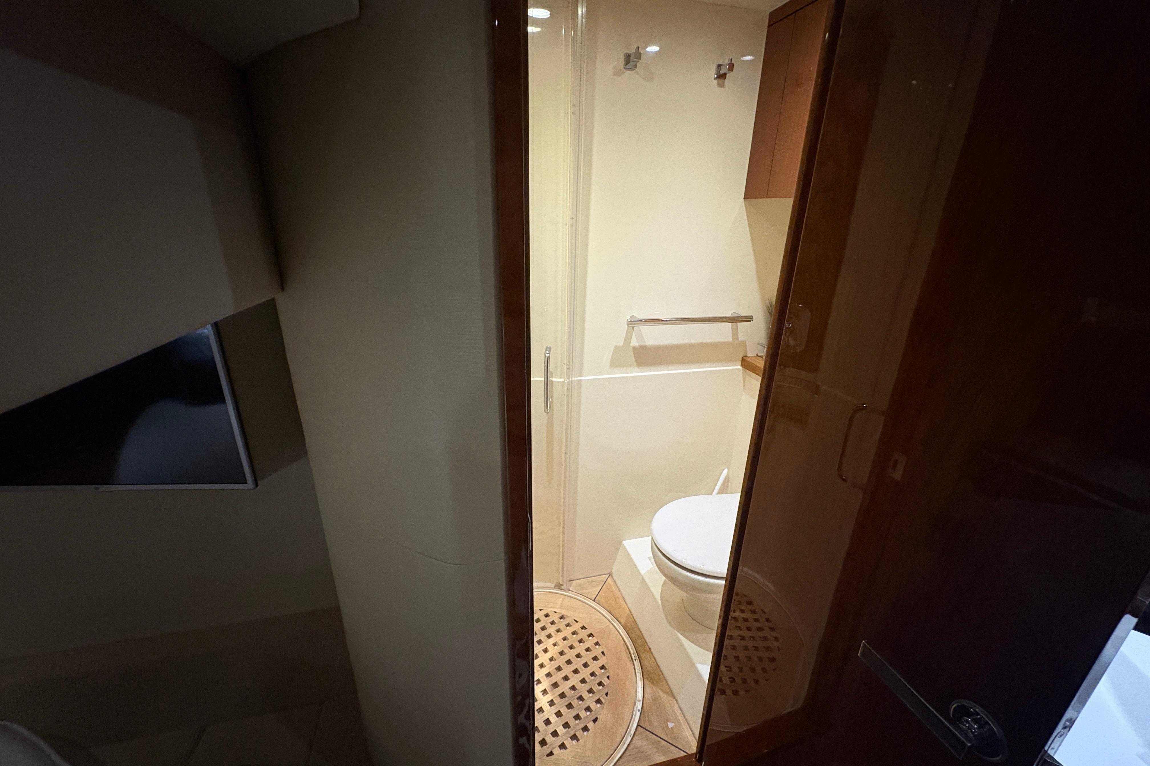 2015 Sea Ray 470 Sundancer bathroom interior with modern fixtures and wooden accents.
