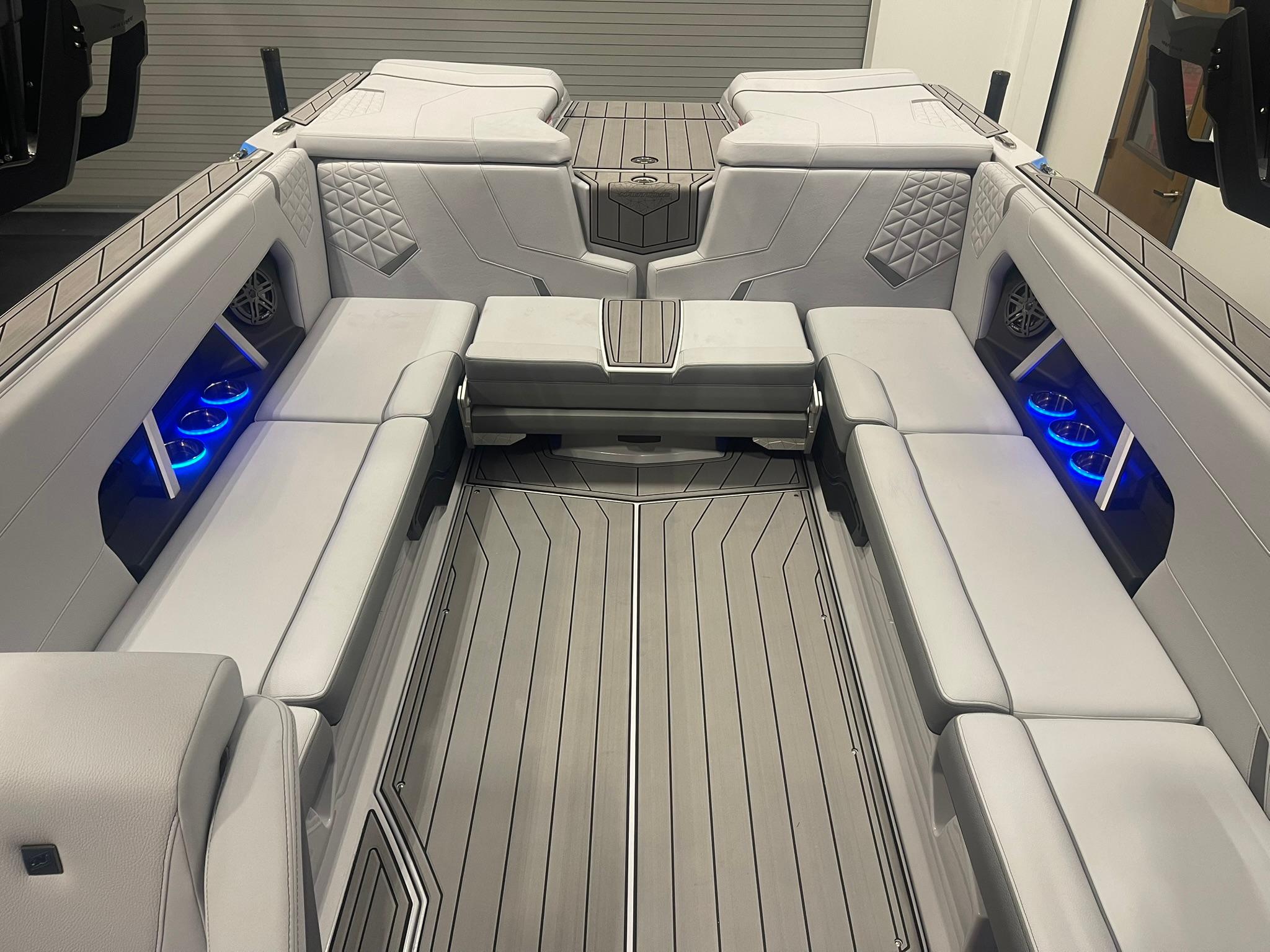 2025 Nautique Super Air Nautique GS24 interior with sleek seating and blue LED lighting.