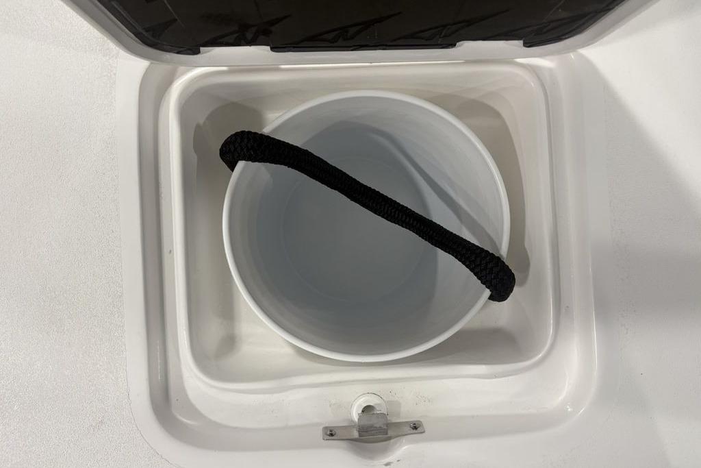 Storage compartment with bucket in 2026 Tidewater 2300 Carolina Bay boat.