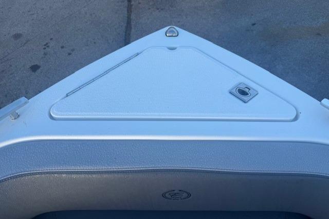 Bow of 2023 Cobalt R6 Surf boat with sleek design and storage compartment.