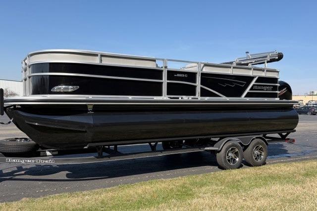 2025 Ranger Reata 223C pontoon boat on trailer, sleek black design, parked outdoors.