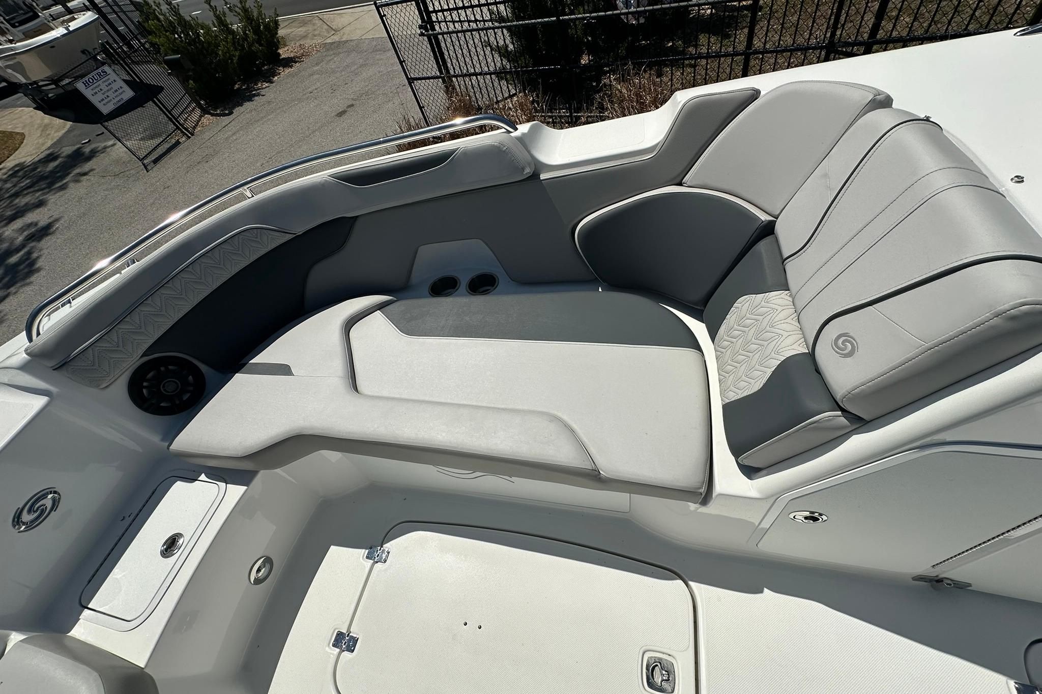 2026 Hurricane SunDeck 2400 OB boat interior with sleek gray seating and modern design.