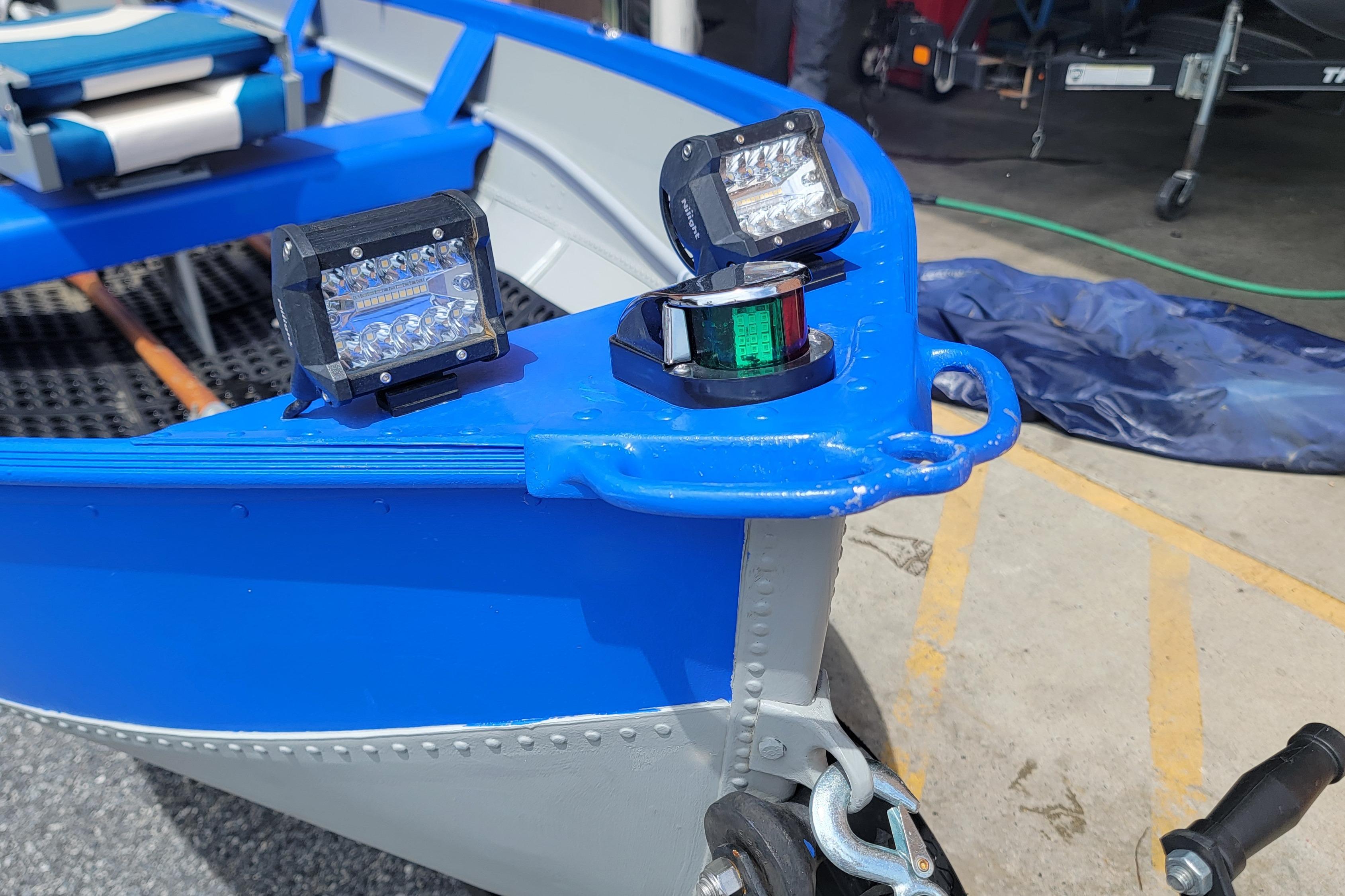 1966 Sea Nymph V-14 boat with modern LED lights on blue and gray hull.
