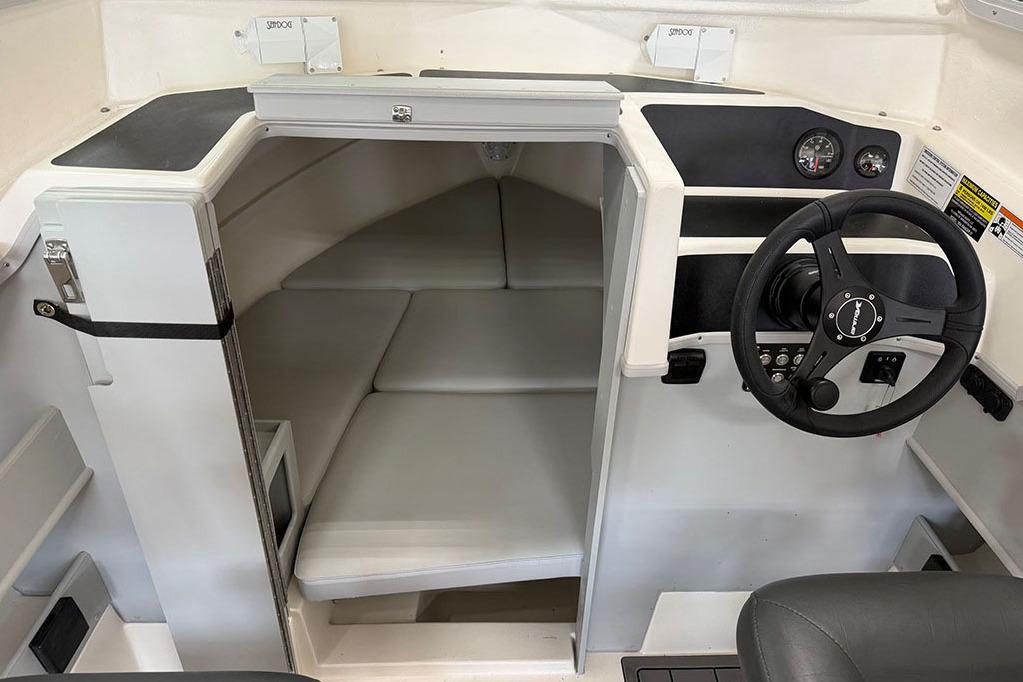 Manufacturer Provided Image: 2026 Arima Sea Ranger 21 Yellowtail Edition cabin interior with steering wheel and seating area.