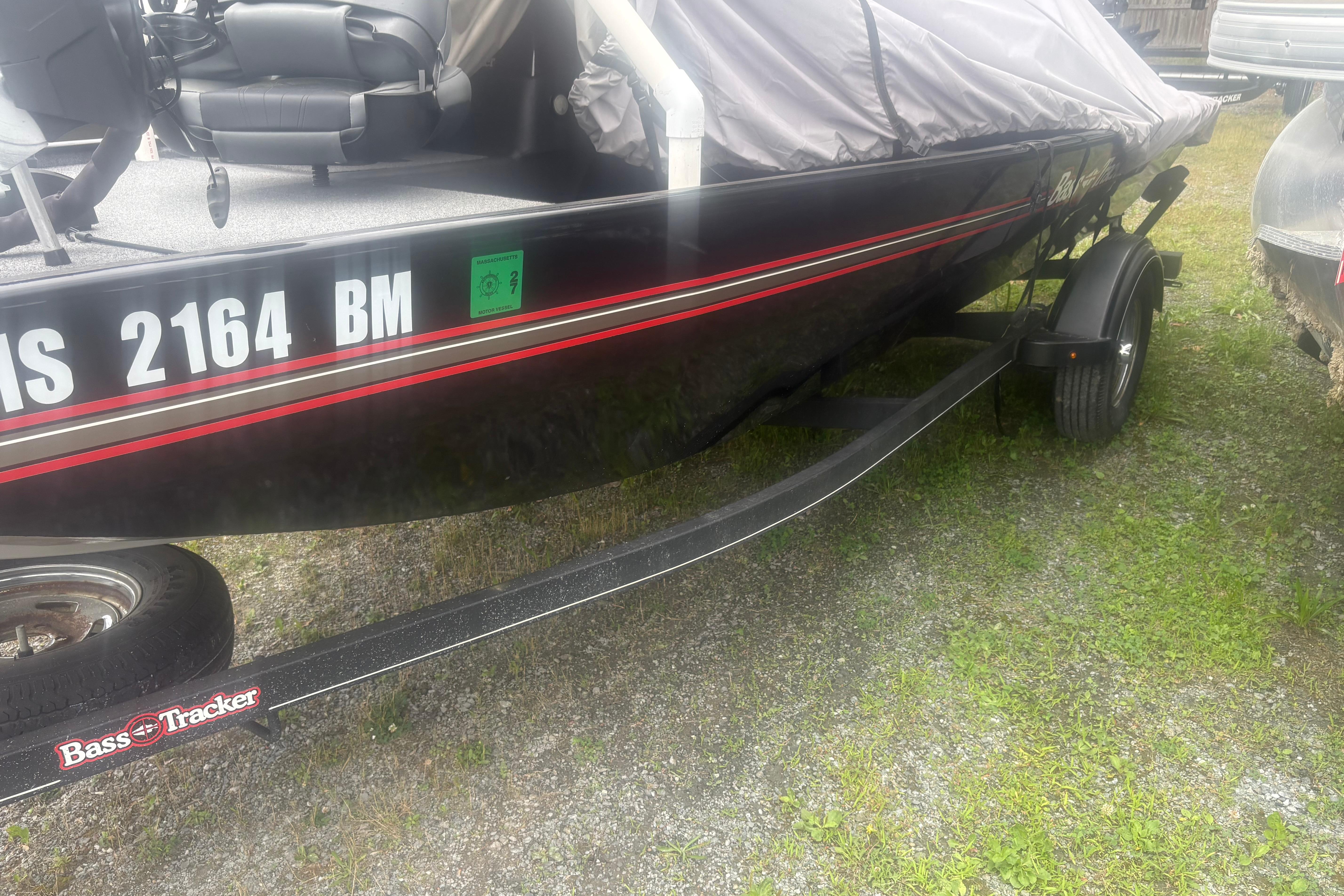 2020 Bass Tracker III Classic boat on trailer, covered and parked on grass.