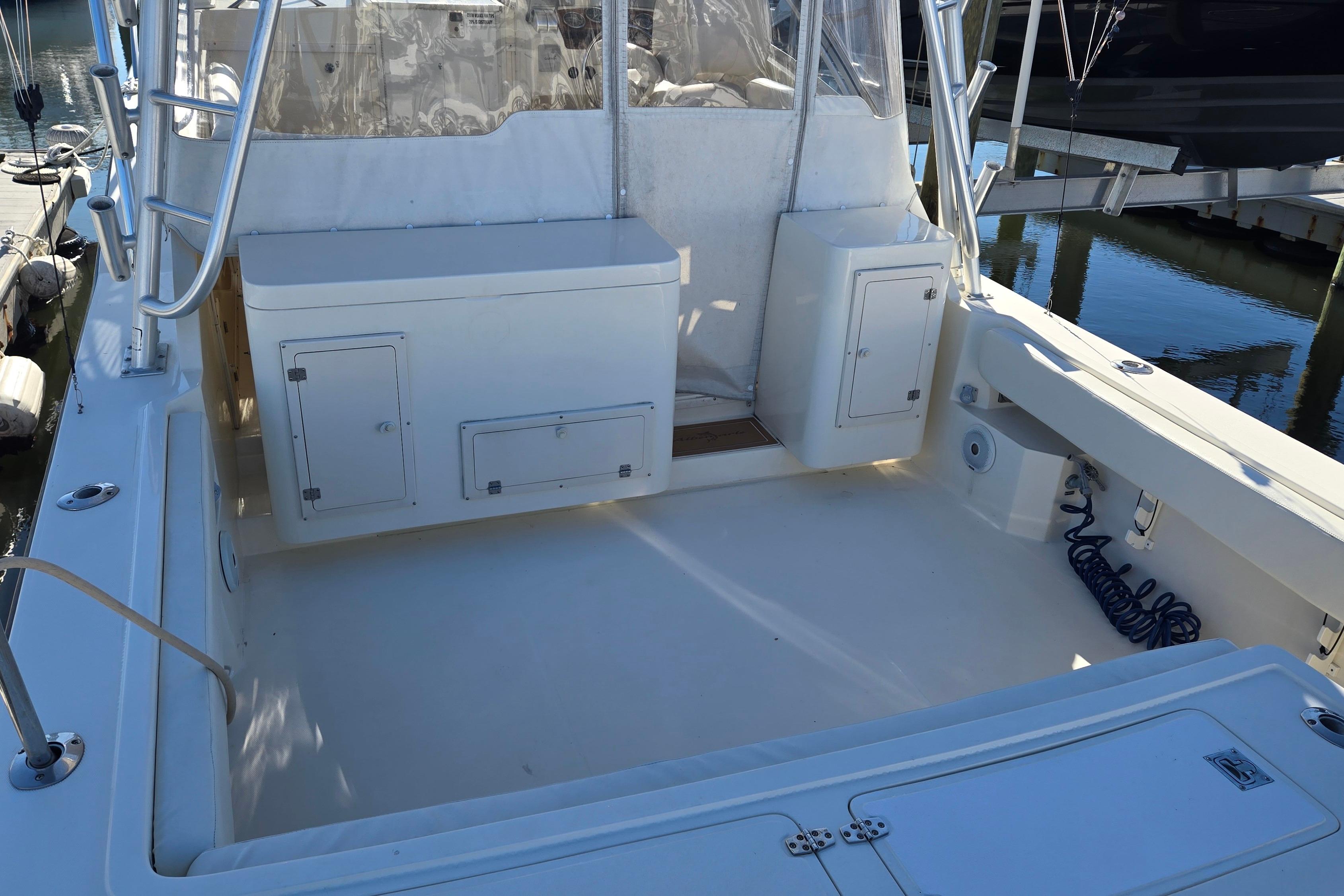 2003 Albemarle 320 Express Fisherman boat deck with storage compartments and clean layout.